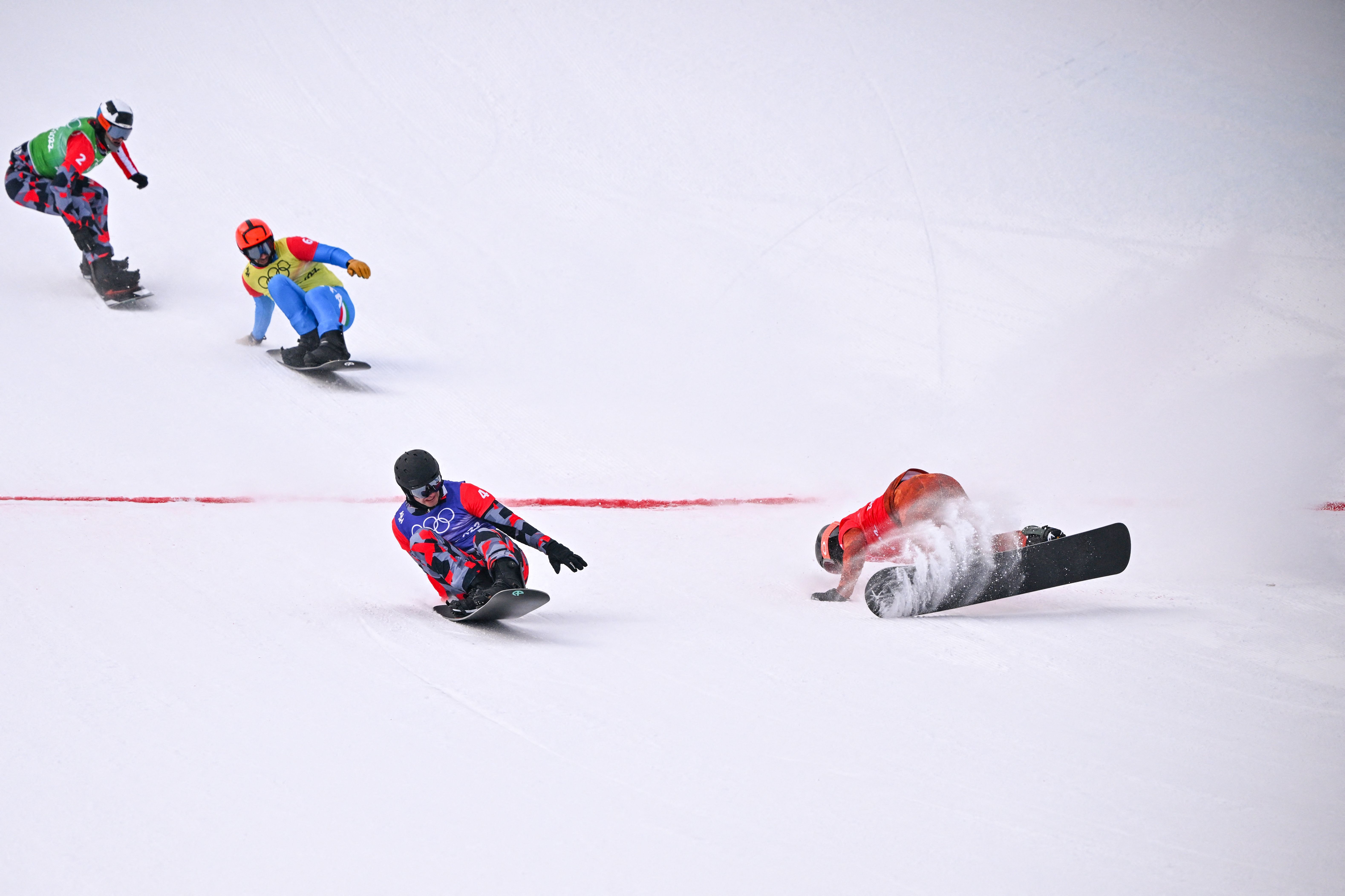 Austria's Alessandro Haemmerle (front L) crosses the finish line ahead of Canada's Eliot Grondin (R) to win the snowboard men's cross big final at the Beijing 2022 Winter Olympic Games 