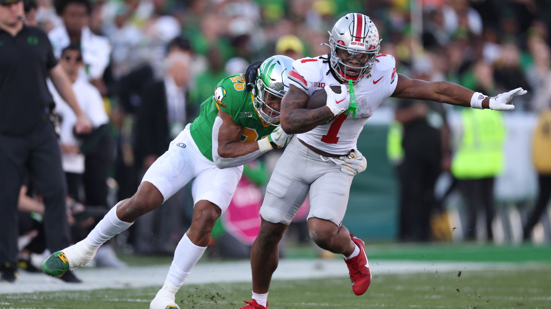 Quinshon Judkins #1 of the Ohio State Buckeyes is tackled by Devon Jackson #26 of the Oregon Ducks in the second quarter during the Rose Bowl Game Presented by Prudential at Rose Bowl Stadium on January 01, 2025 in Pasadena, California.