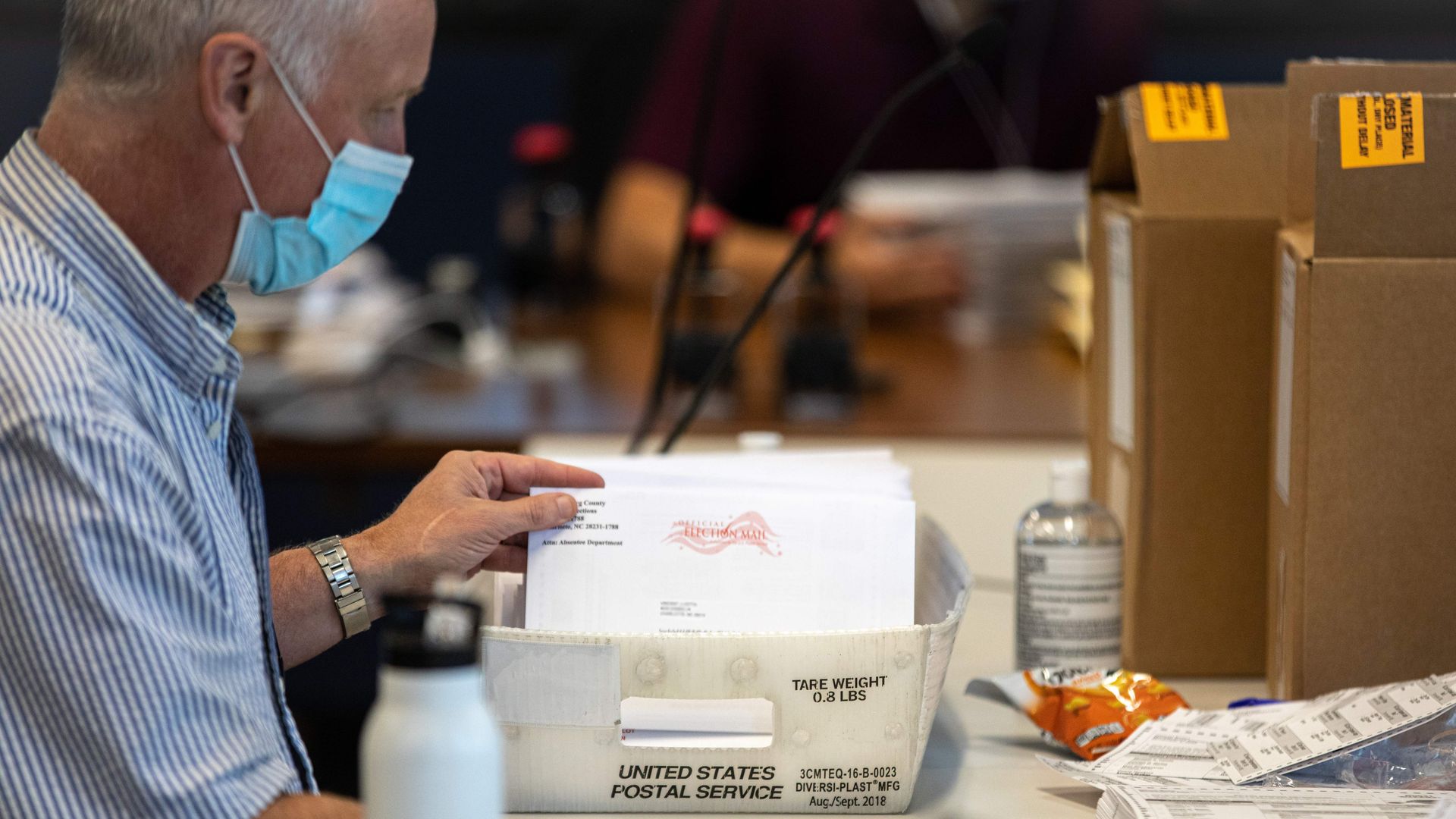 Absentee ballot election workers stuff ballot applications at the Mecklenburg County Board of Elections office in Charlotte, North Carolina on September 4