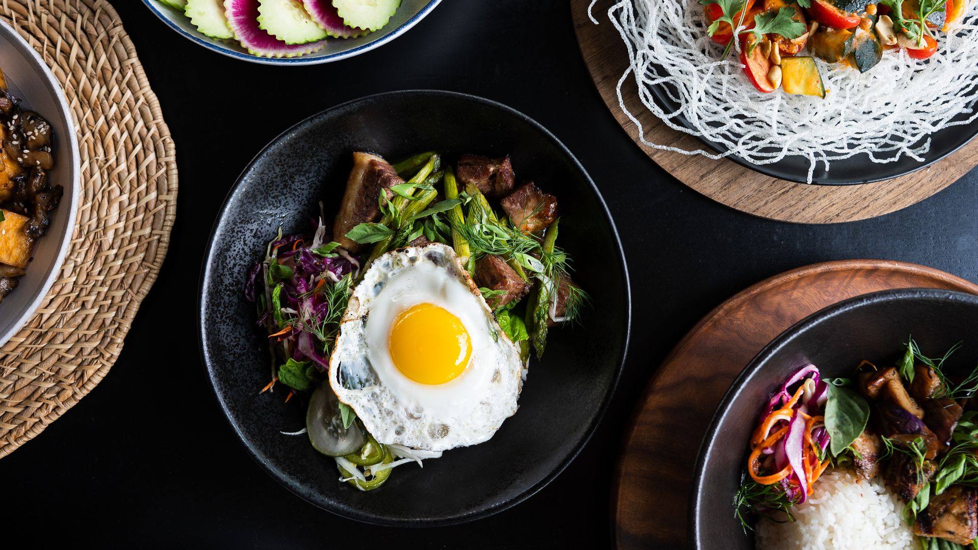 A photo of plates filled with various rice dishes on a table.