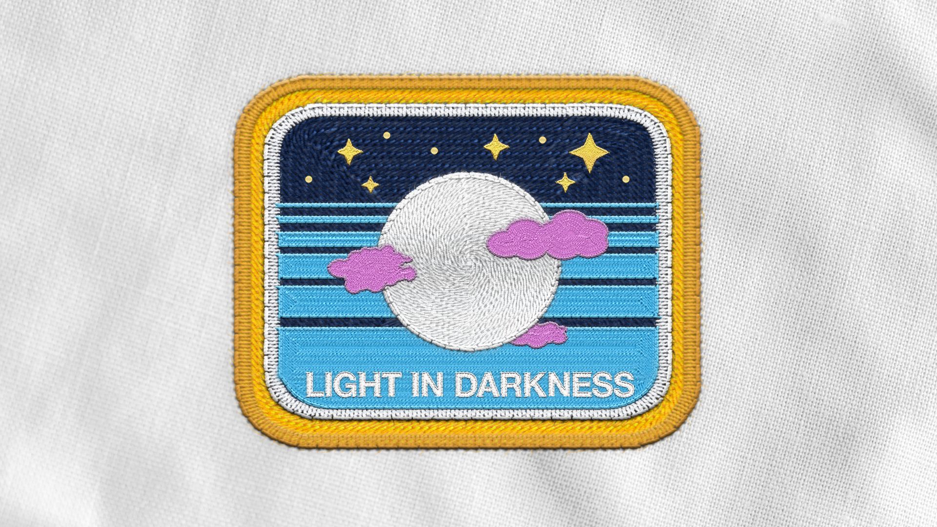 Illustration of an astronaut badge depicting the moon obscured by clouds, the words "LIGHT IN DARKNESS" are on the badge. 