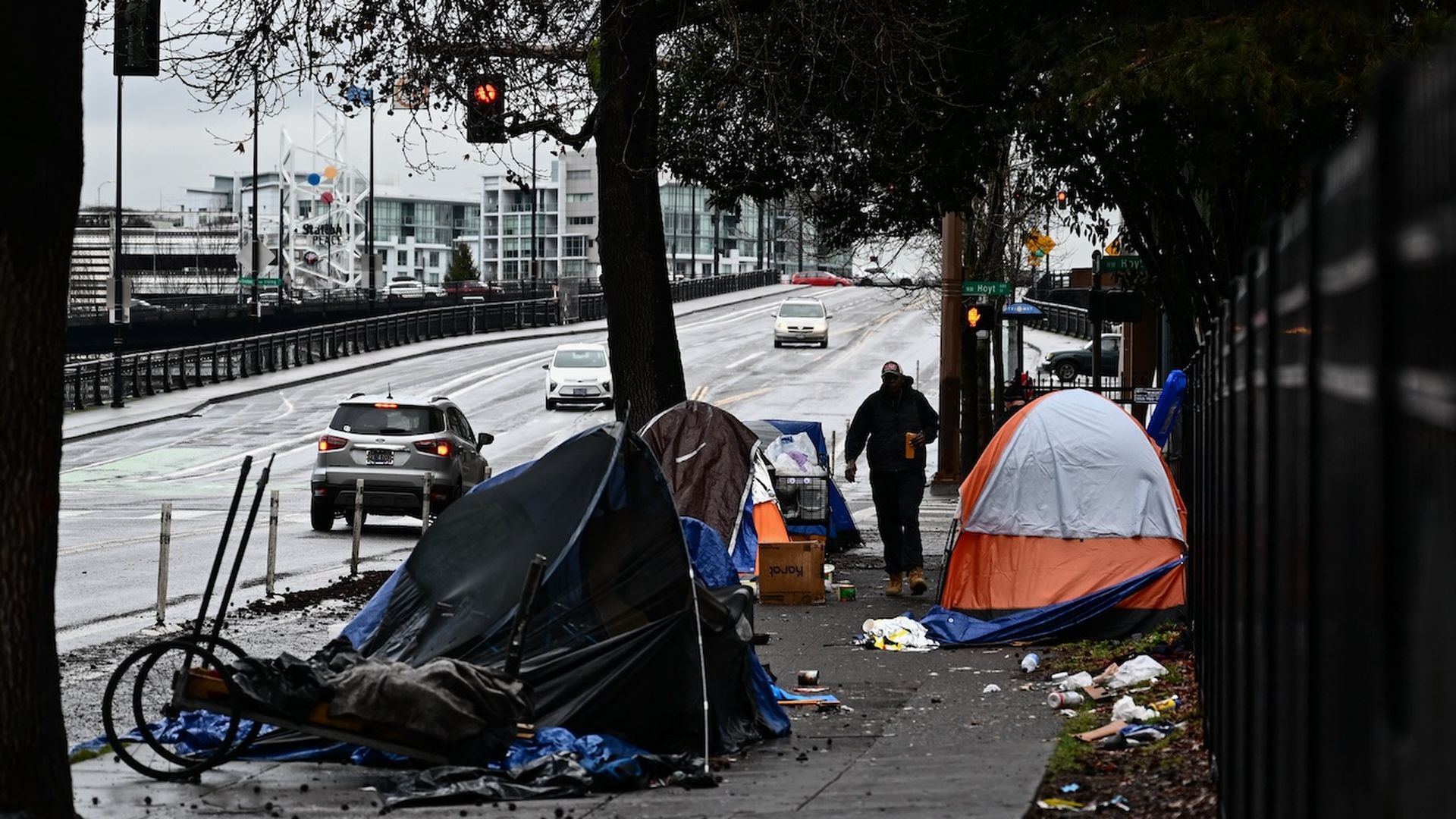 A photo shows several tents lining a sidewalk.
