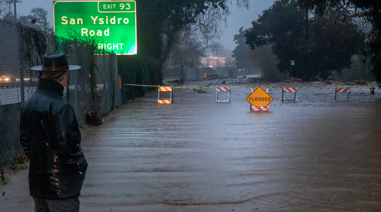 Lifelong Montecito resident George Quirin, 63, looks at a flooded Jameson Lane in Montecito, a result of San Ysidro Creek overflowing due to heavy rainfall in the area. P