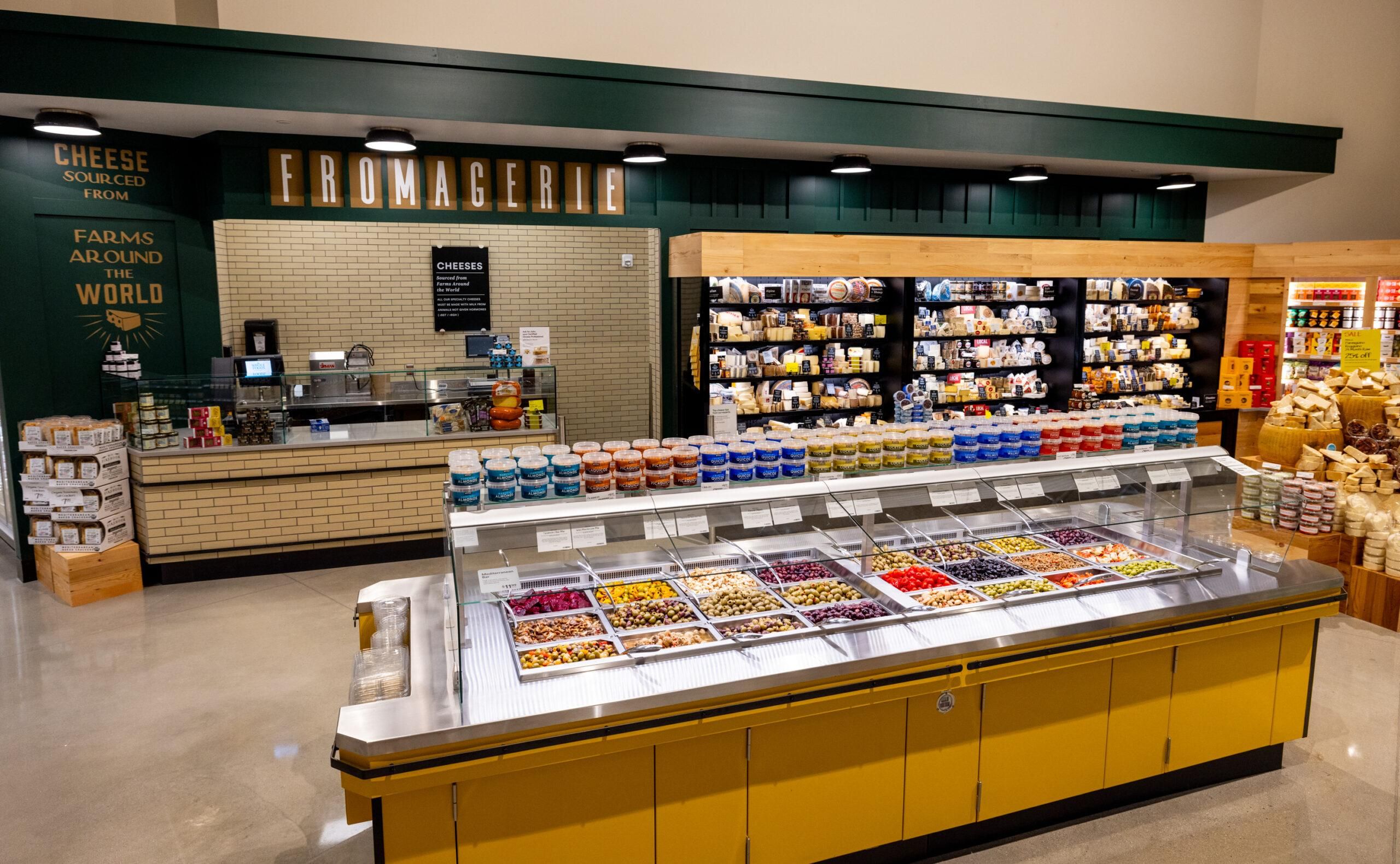A view of the interior of Whole Foods with an olive bar