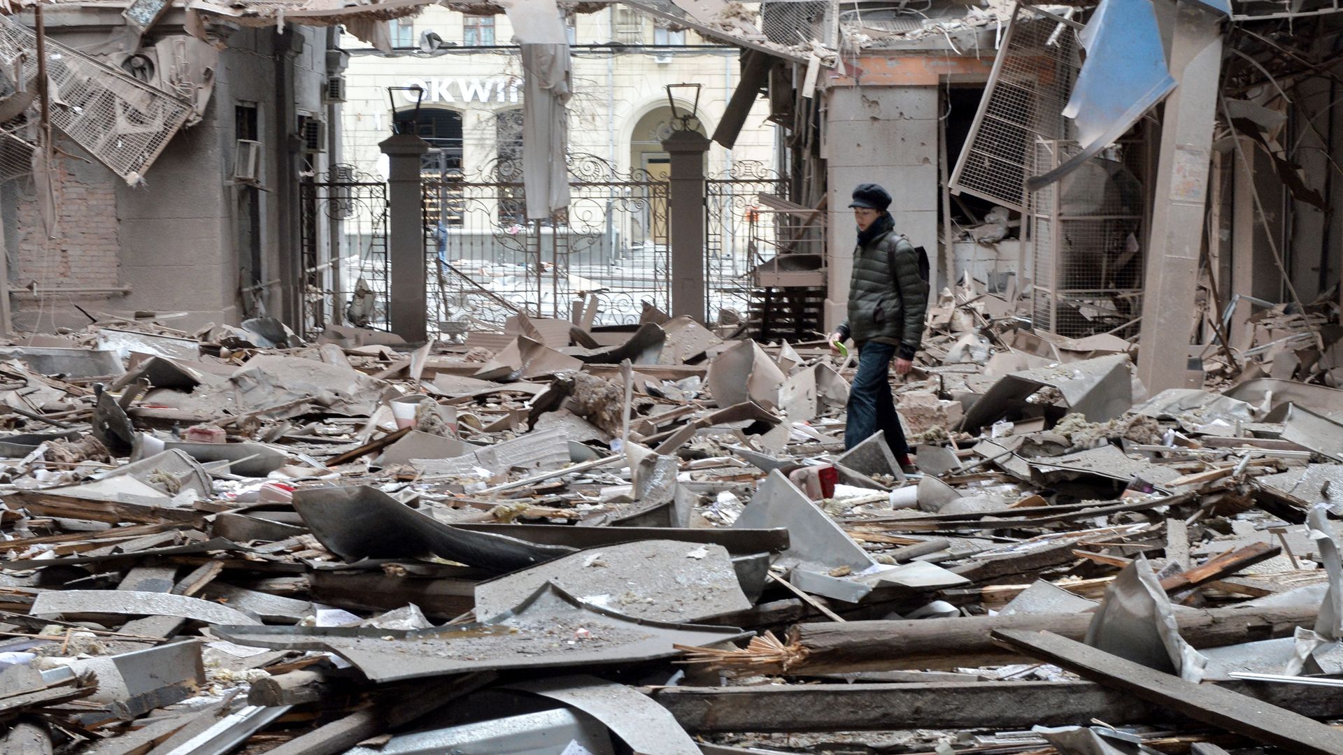 Picture of a person walking among rubble
