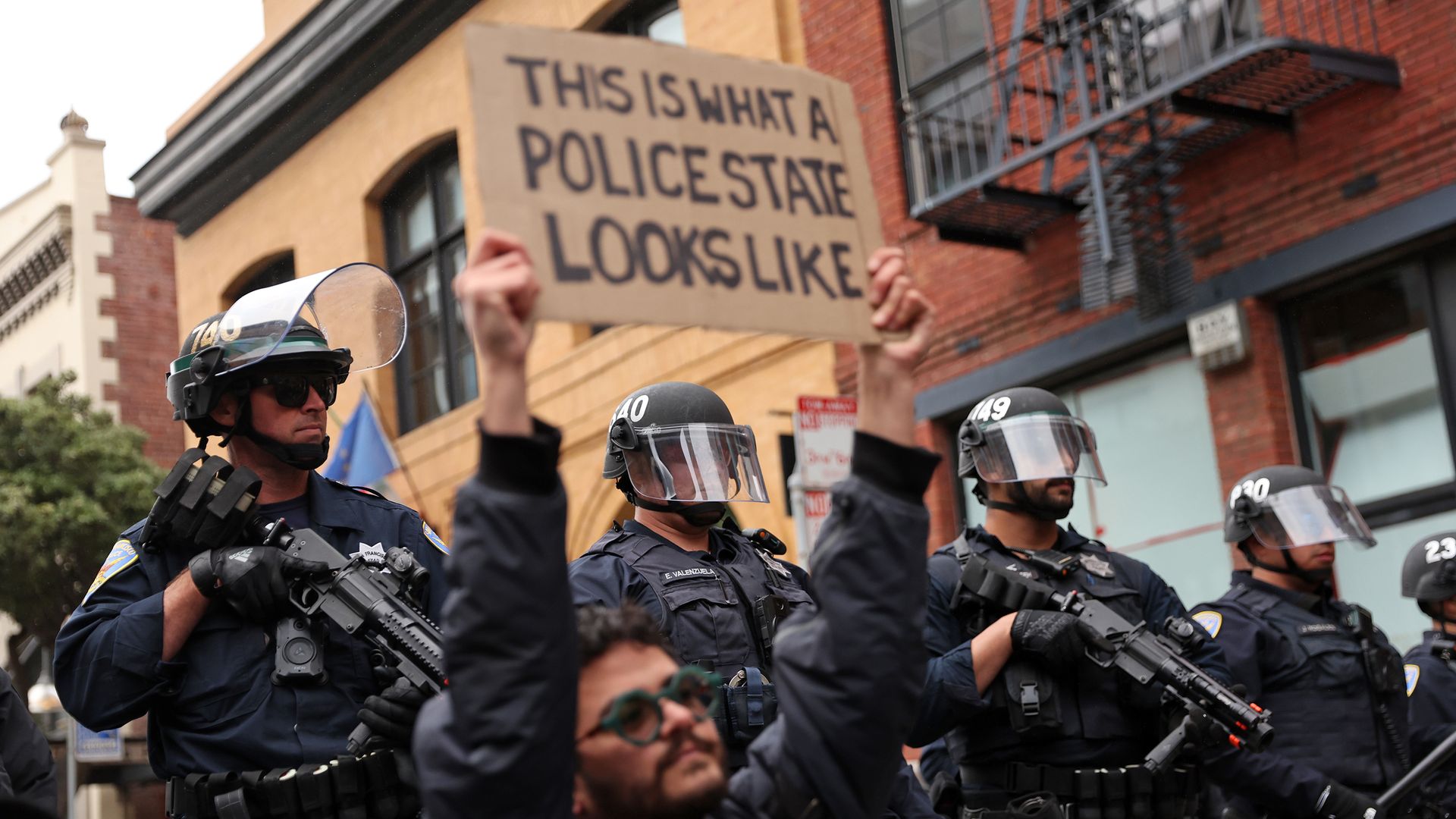 An ICE Out of The Bay protester kneels in front of SFPD near ICE headquarters on Sansome Street in San Francisco on Sunday, June 8, 2025. (Photo by Scott Strazzante/San Francisco Chronicle via Getty Images)