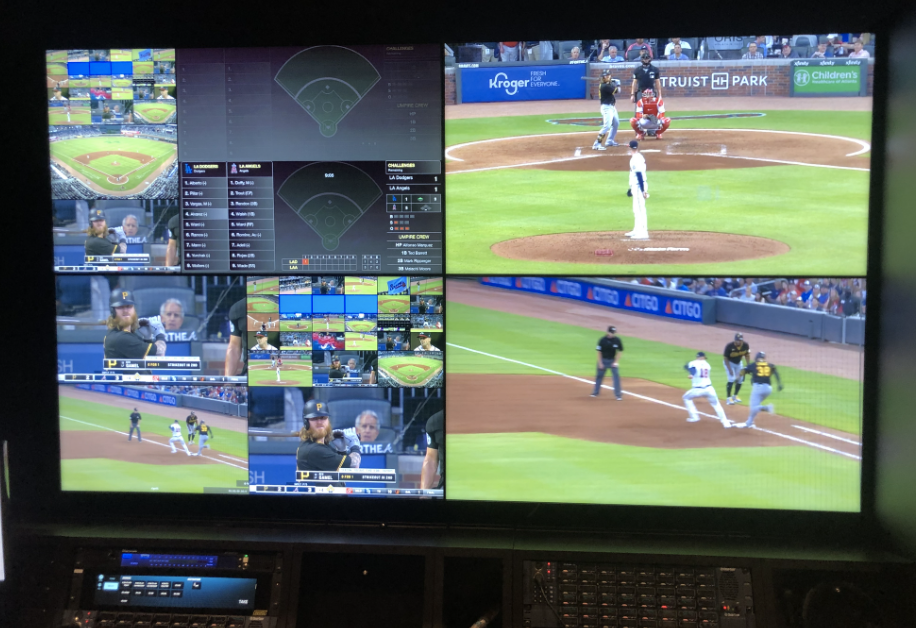 Multiple monitors show different camera angles of play under review.