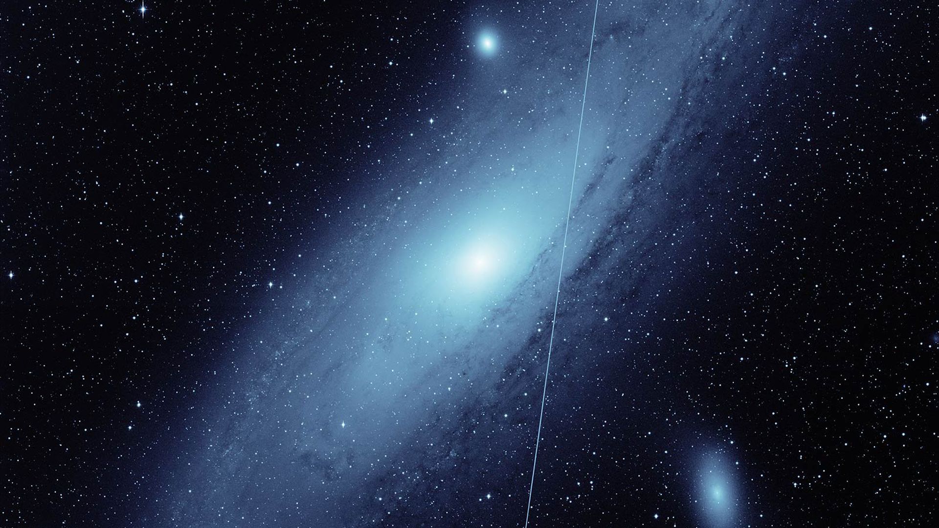 The Andromeda Galaxy with a streak from a satellite going across the view