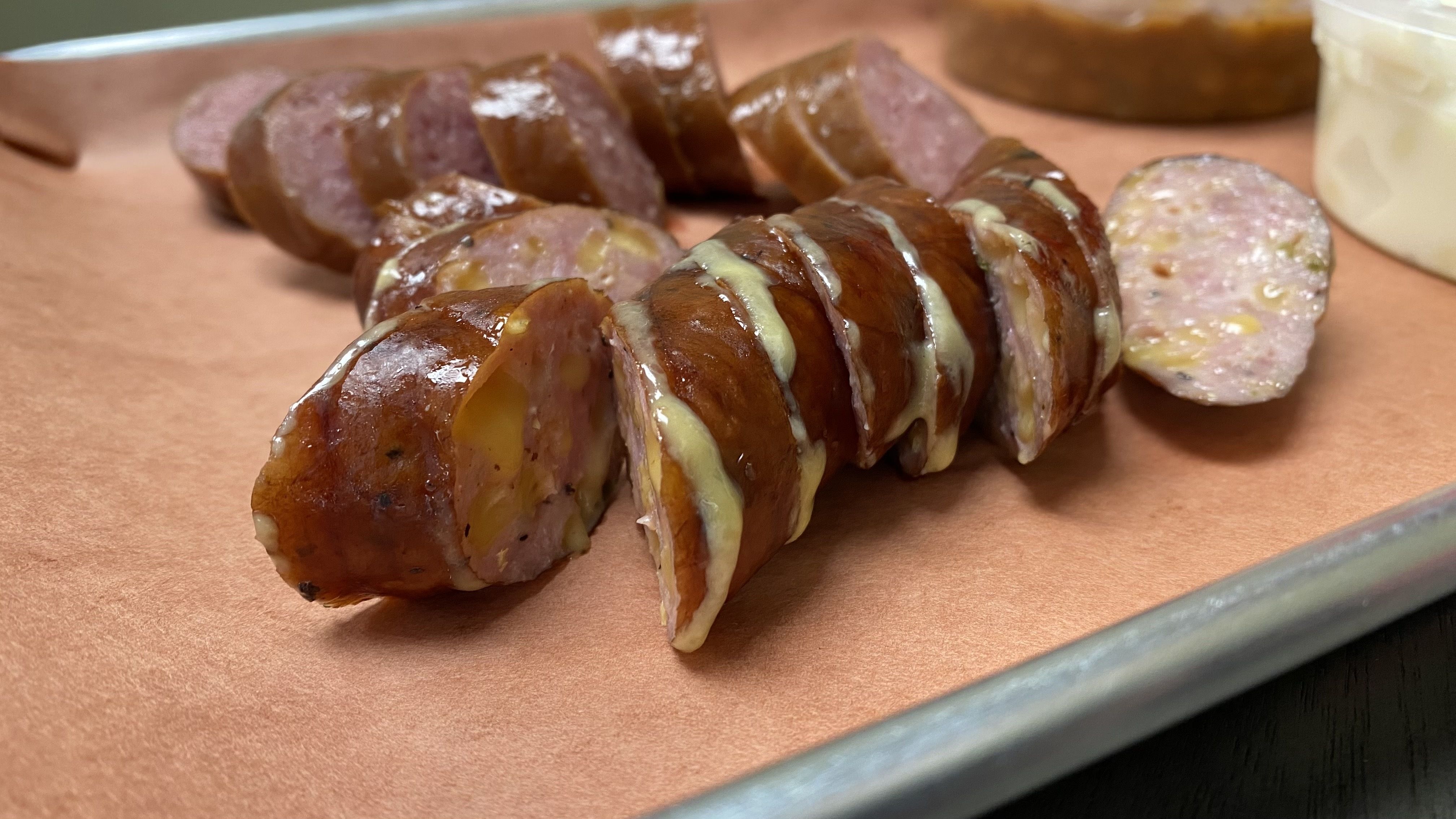 A plate of sausage cut into bite sizes. 