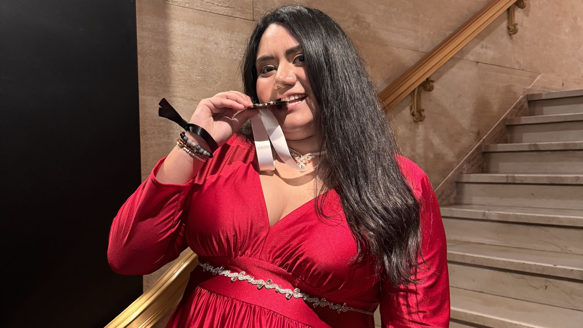 Ana Liz Pulido bites her James Beard medal after winning Best Chef in Texas.