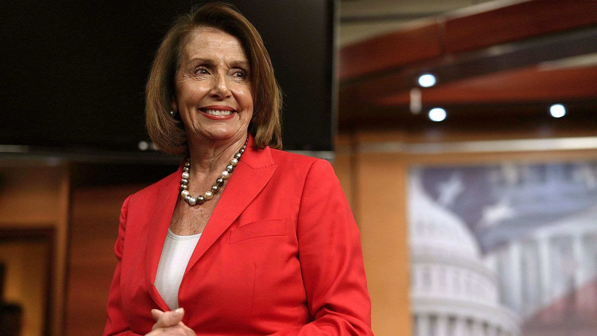 Nancy Pelosi wearing a red pantsuit