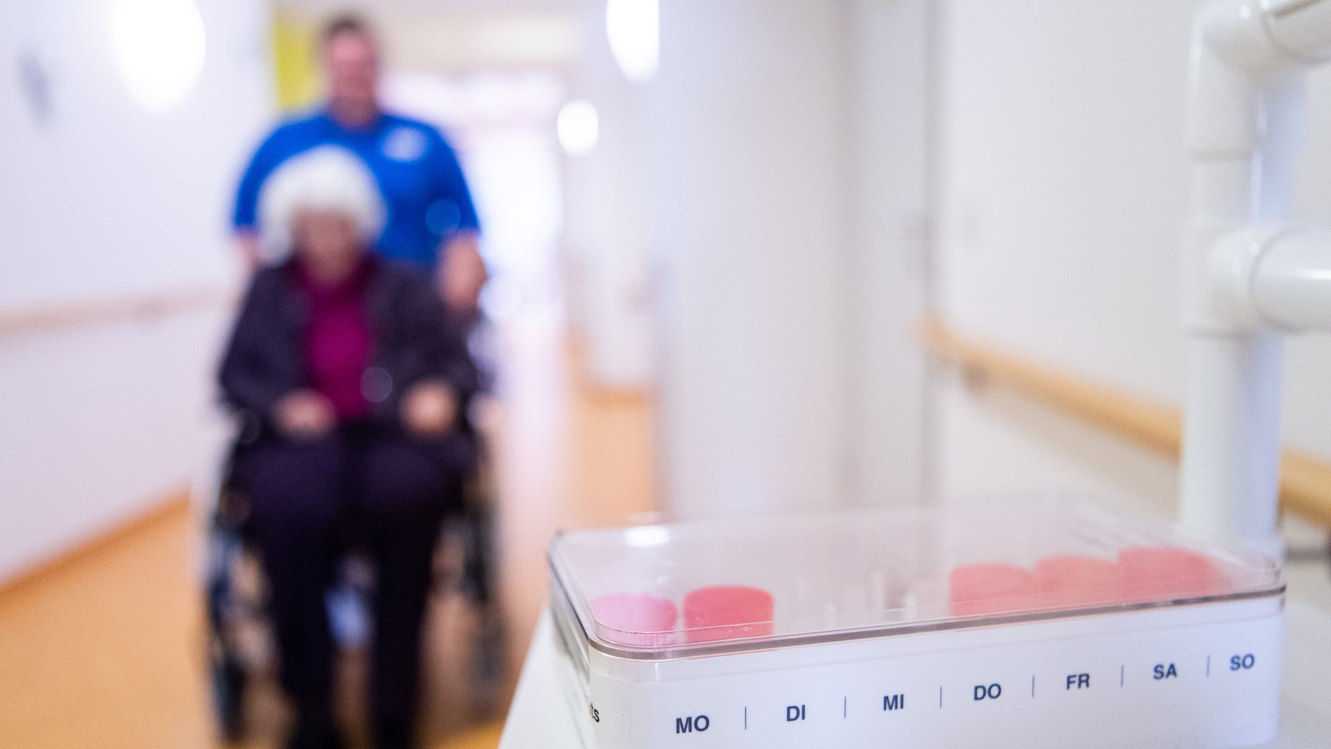 In a nursing home, a box of tablets stands on a supply trolley in the hallway.