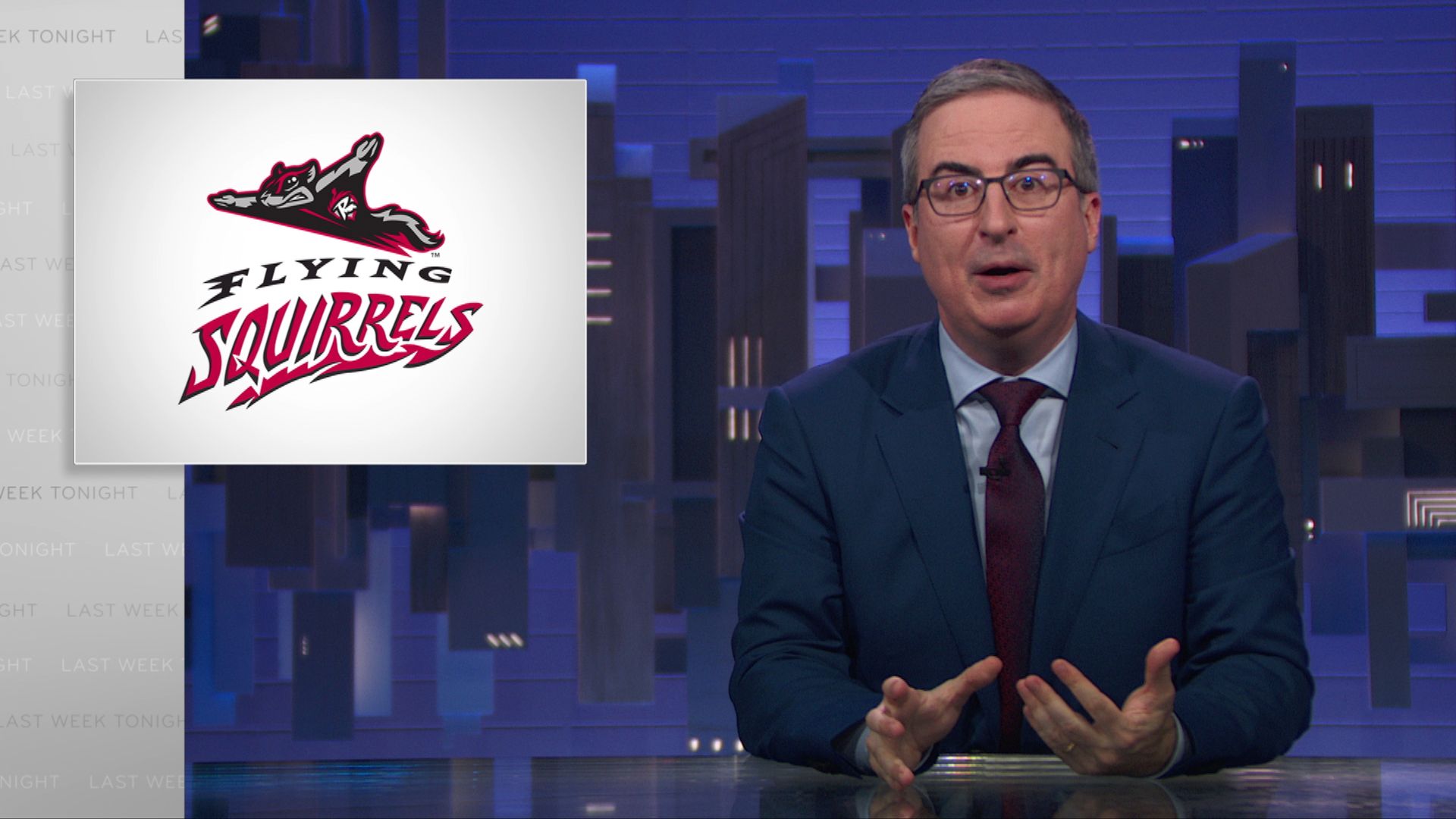 John Oliver with the Richmond Flying Squirrels logo next to him. 