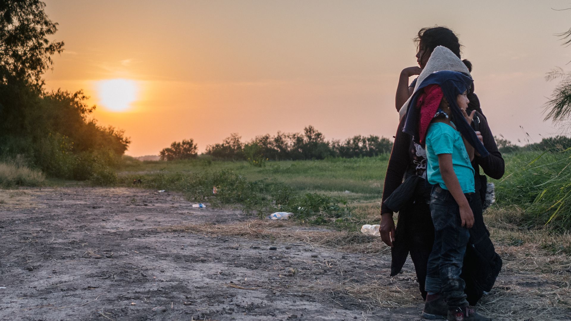 A migrant family wait to be accounted for and taken to a border patrol processing facility after crossing the Rio Grande into the U.S.