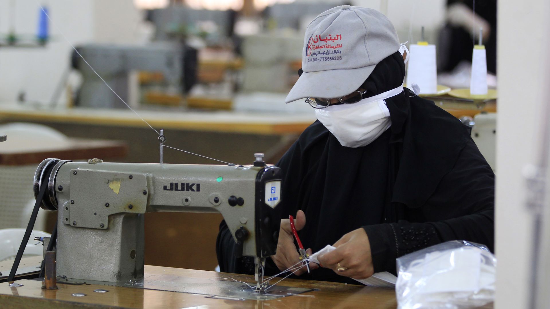 A Yemeni woman makes face masks at a textile factory in the capital Sanaa on March 16