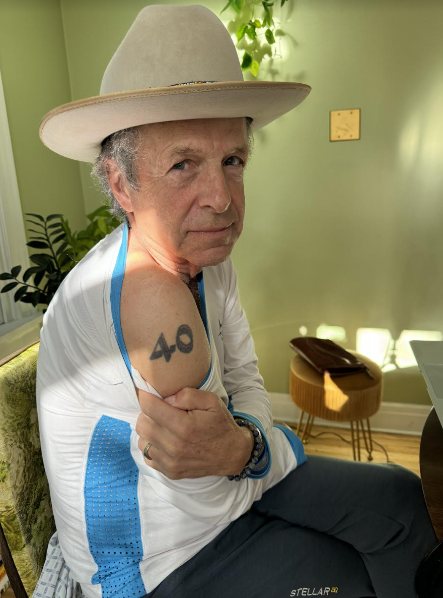 The number 40 tattooed on a man's shoulder