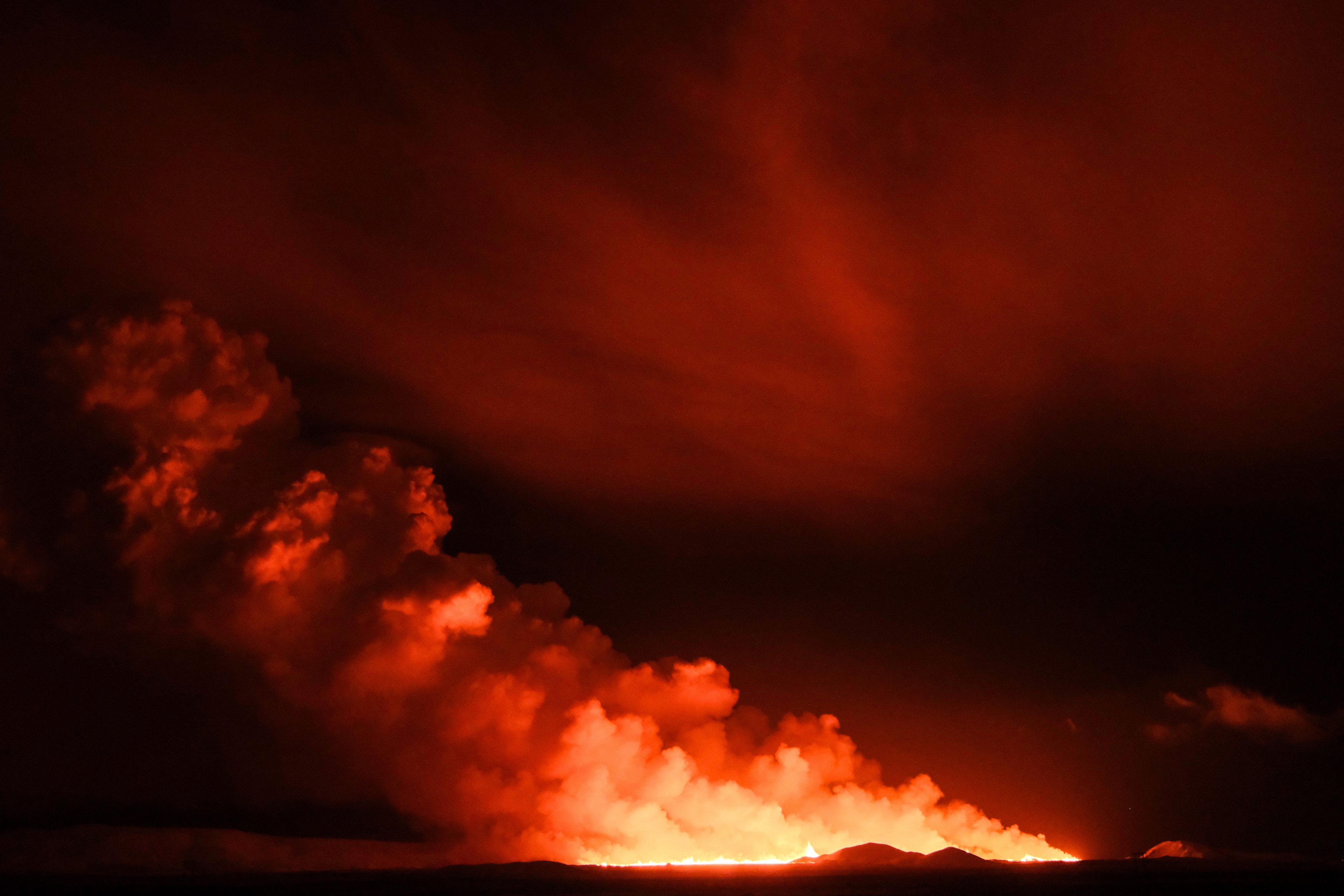 Flowing lava is seen during at a fissure on the Reykjanes peninsula 3km north of Grindavik, western Iceland on December 18, 2023. A volcanic eruption began on Monday night in Iceland, south of the capital Reykjavik, following an earthquake swarm, Iceland's Meteorological Office reported.