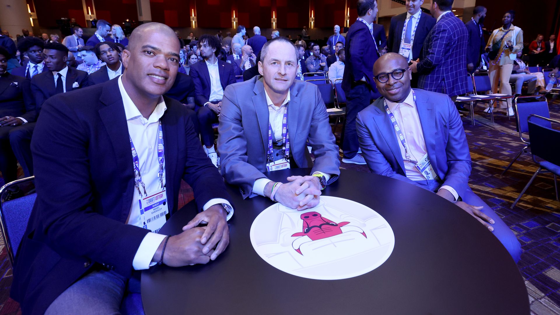 basketball players and a coach sitting at a table