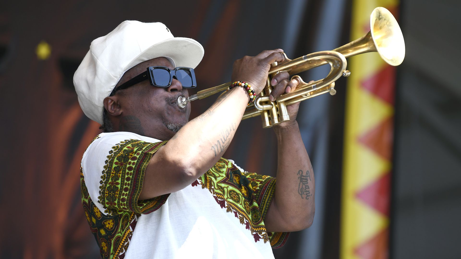 Photo shows Kermit Ruffins playing a horn.