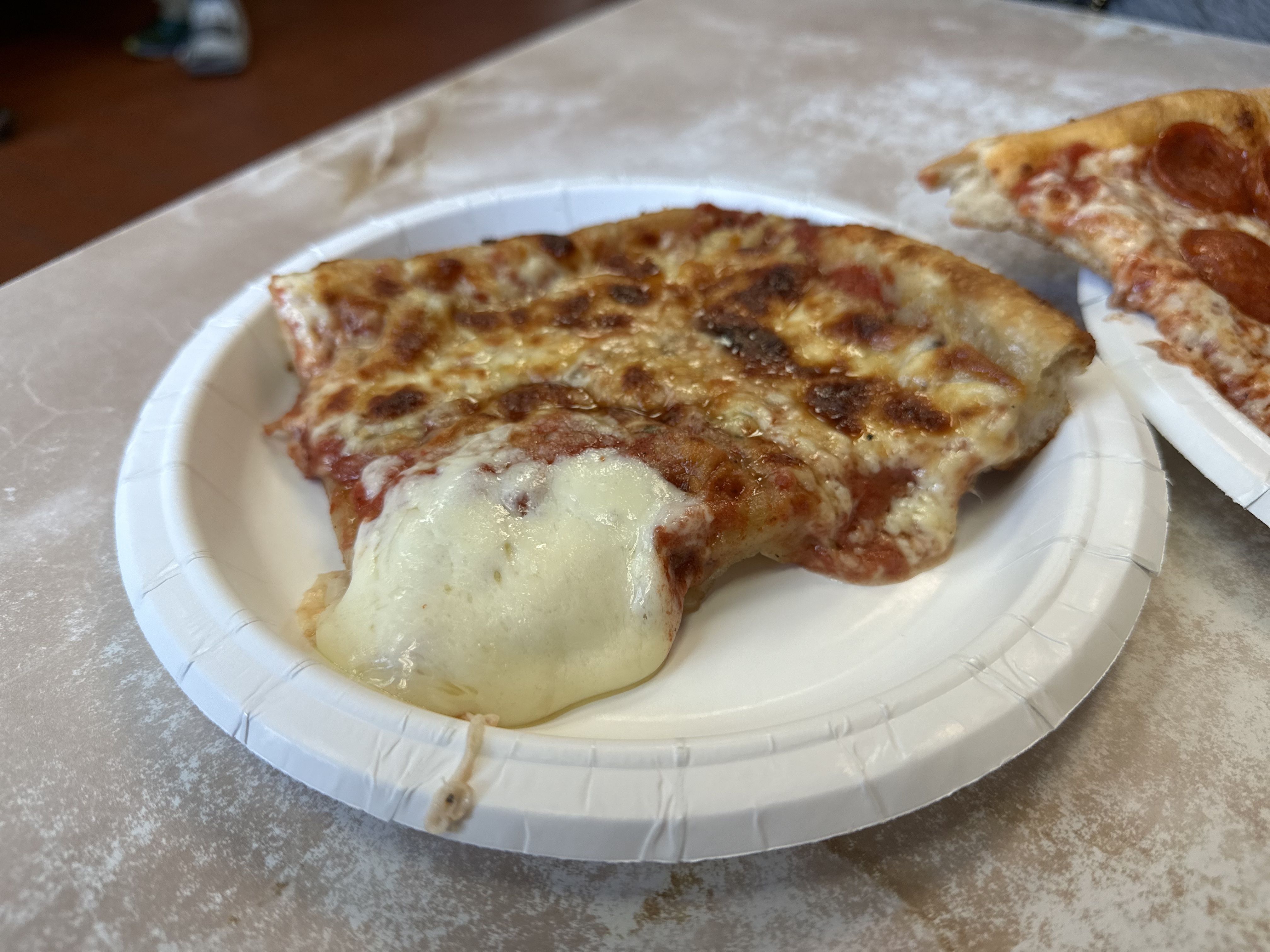 A Sicilian cheese slice that looks like it had an extra glob of mozzarella from Armando's pizza in Cambridge.