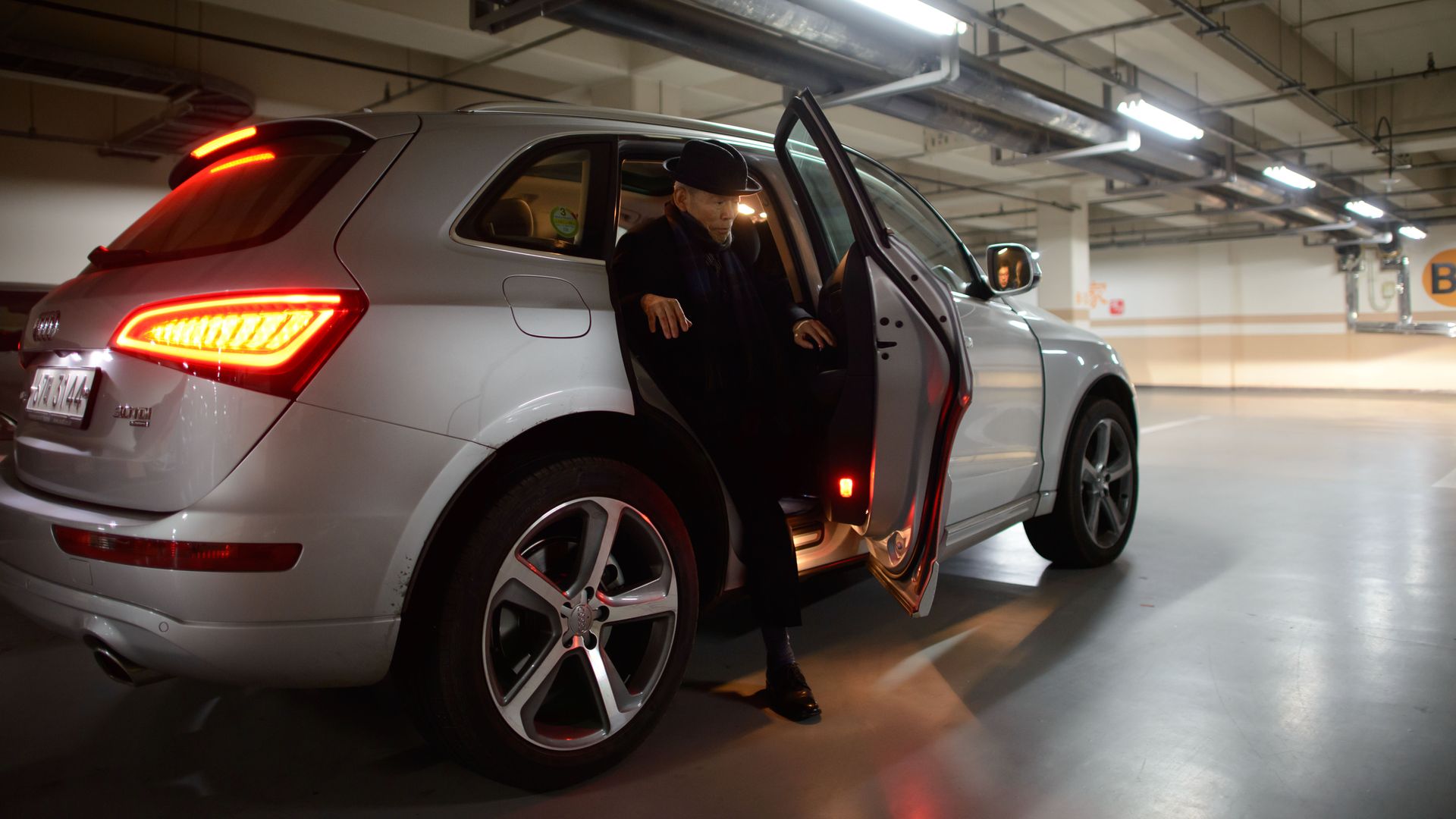 Photo of a man getting out of a car