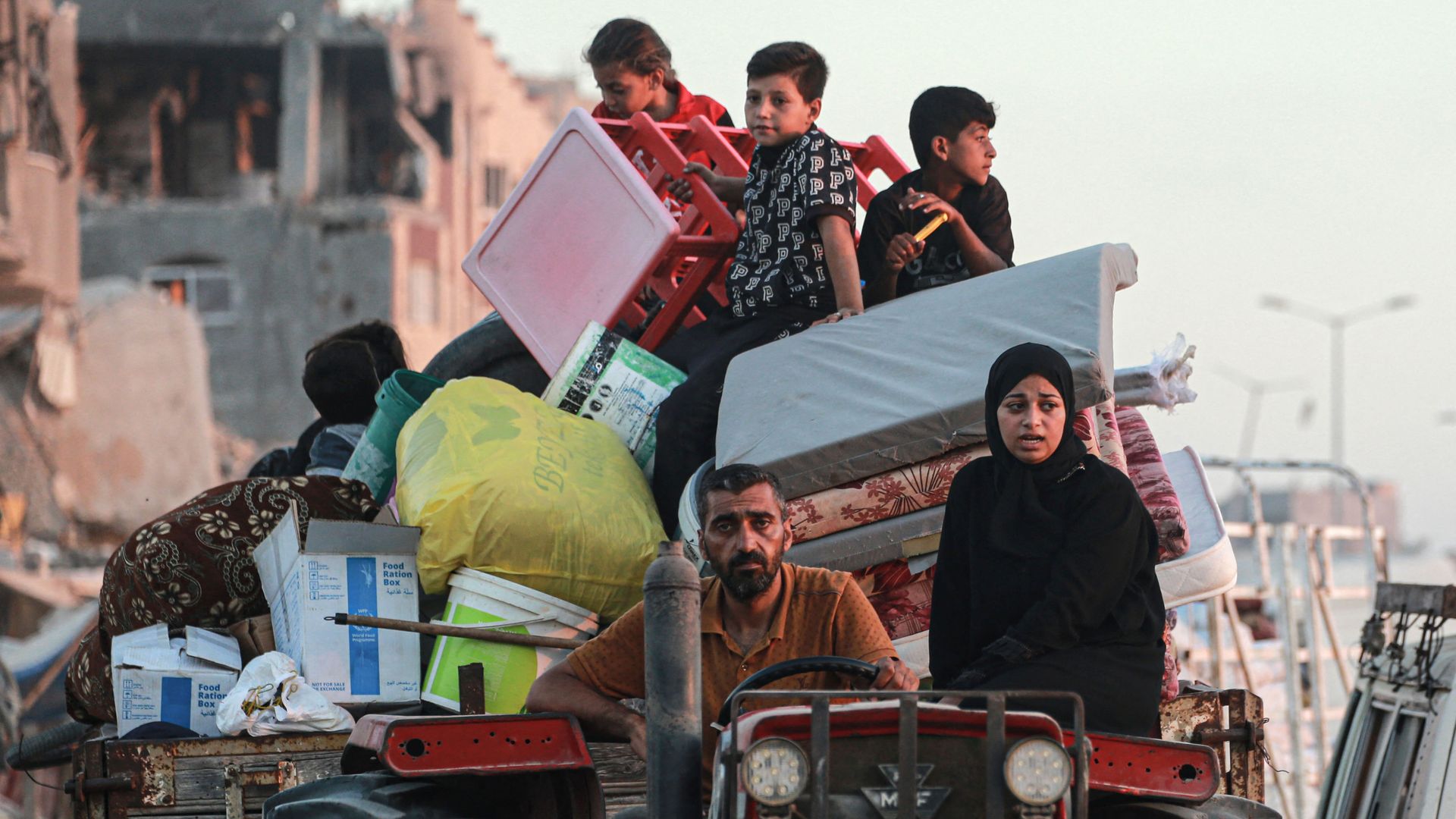 Displaced Palestinians leave an area in east Khan Yunis after the Israeli army issued a new evacuation order for parts of the city and Rafah, in the southern Gaza Strip on July 1, 2024
