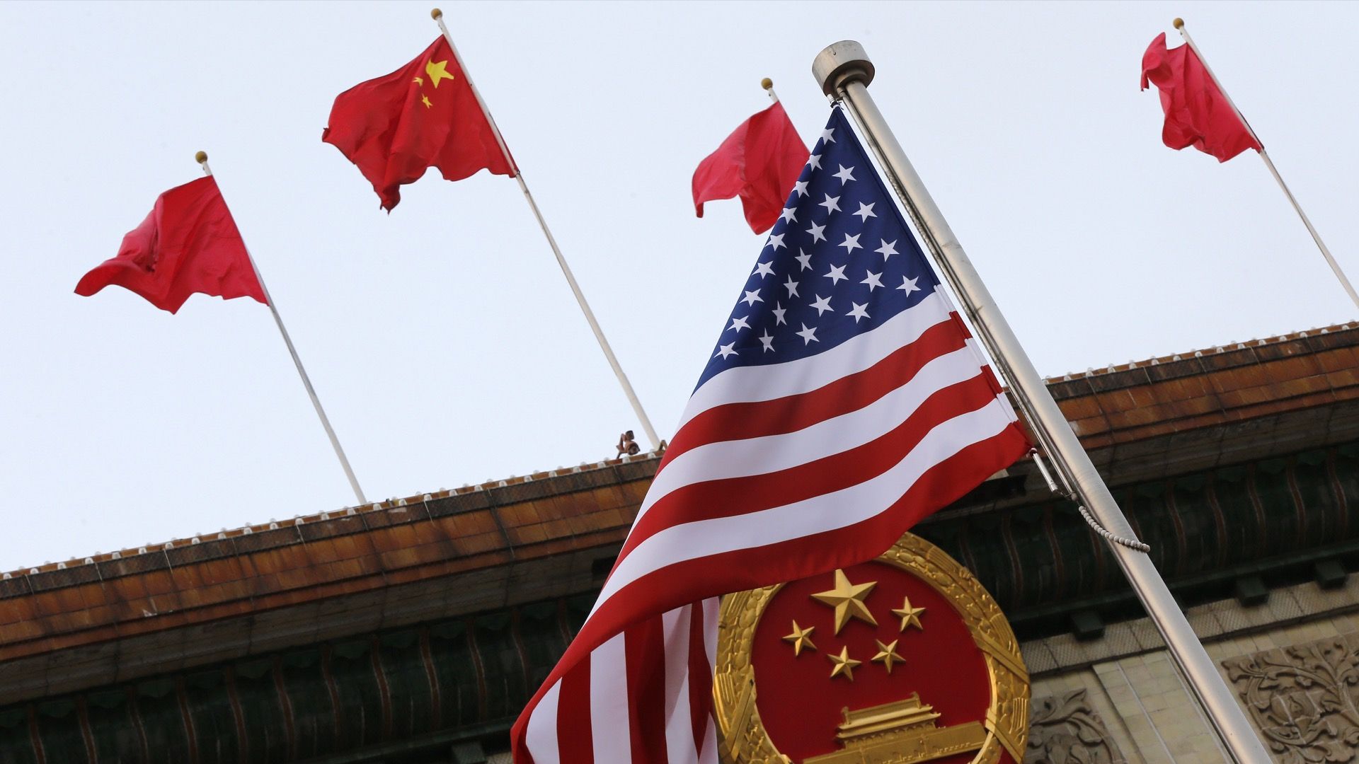 Chinese and American flags wave