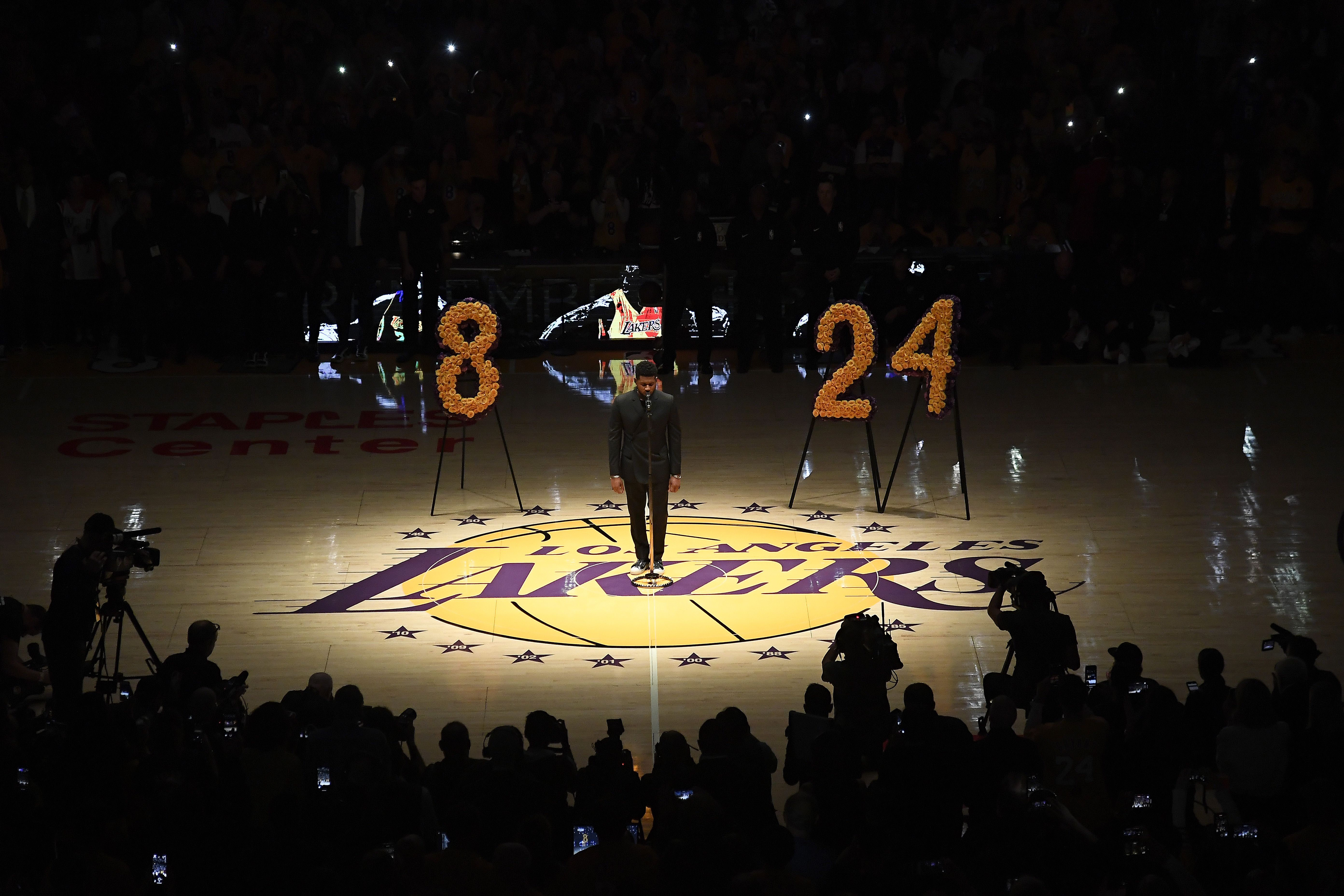 In this image, the lights are dimmed on the court as a large 8 and 24 are displayed next to each other