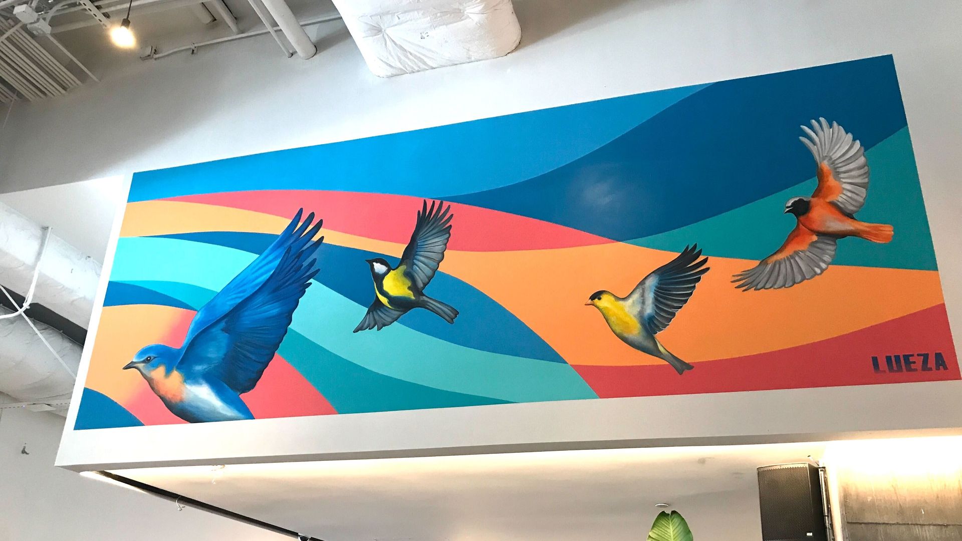A mural depicting colorful birds.