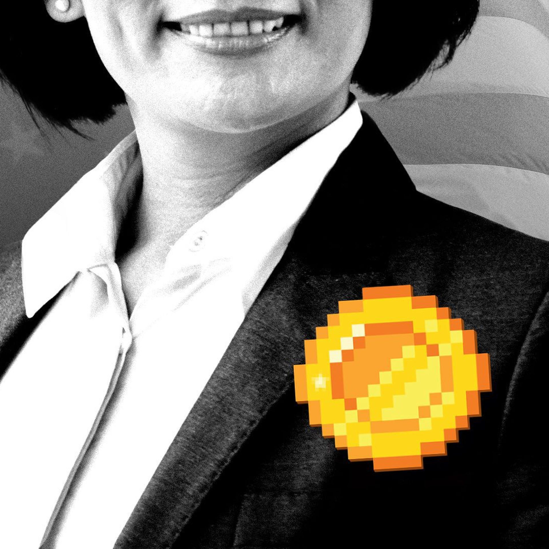 A woman in a suit with a digital coin on her lapel.