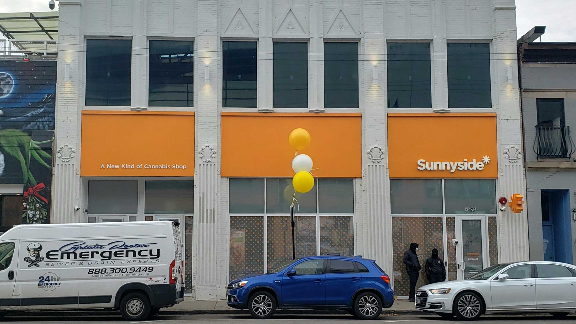 A photo of a building with cars in front of it.