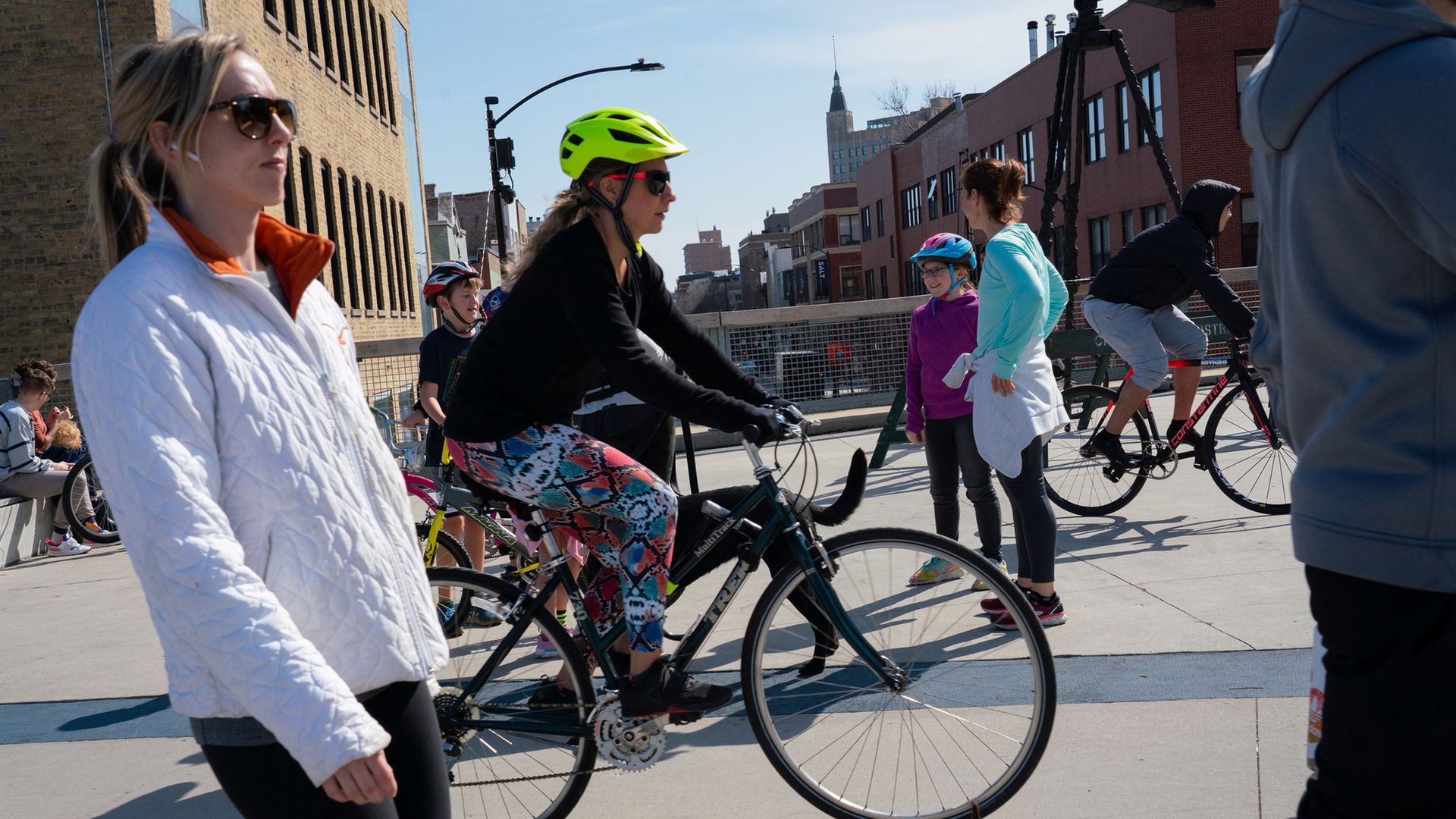 People walk and bike on a pedestrian trail