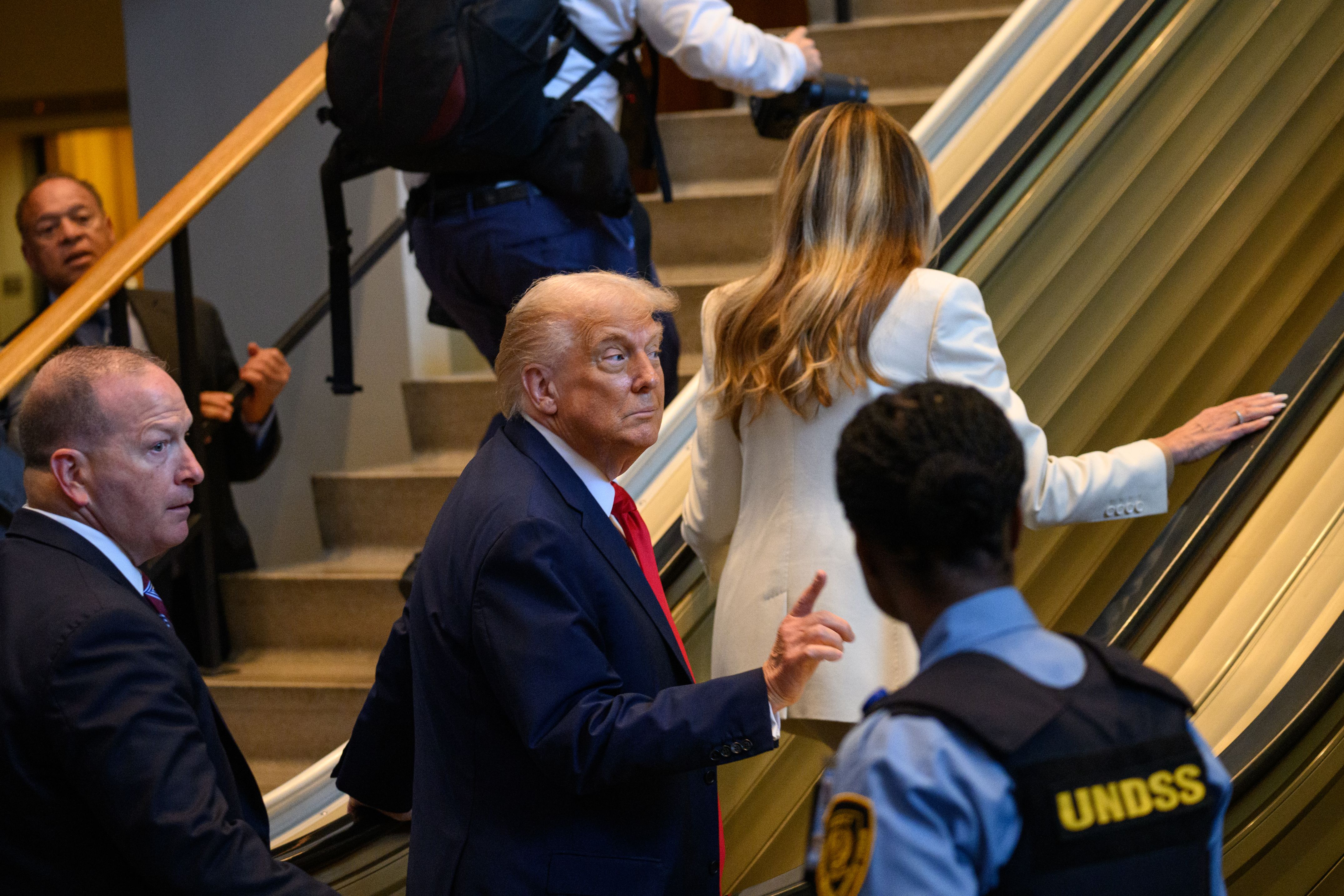 President Trump gestures after an escalator at the UN abruptly stopped shortly after he stepped onto it yesterday.