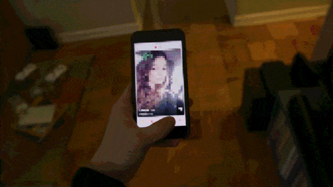Person swiping through profiles on a dating app.