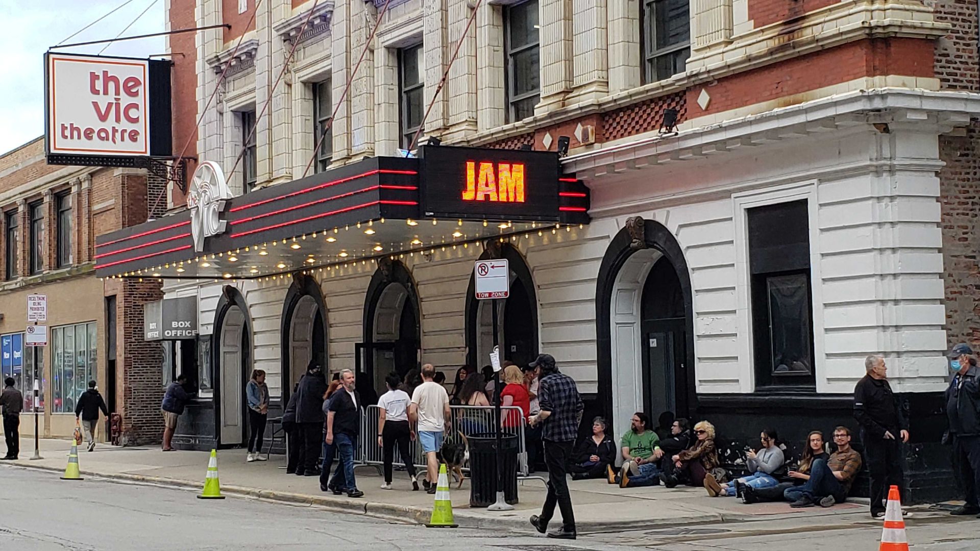 A line of people outside the Vic Theatre.