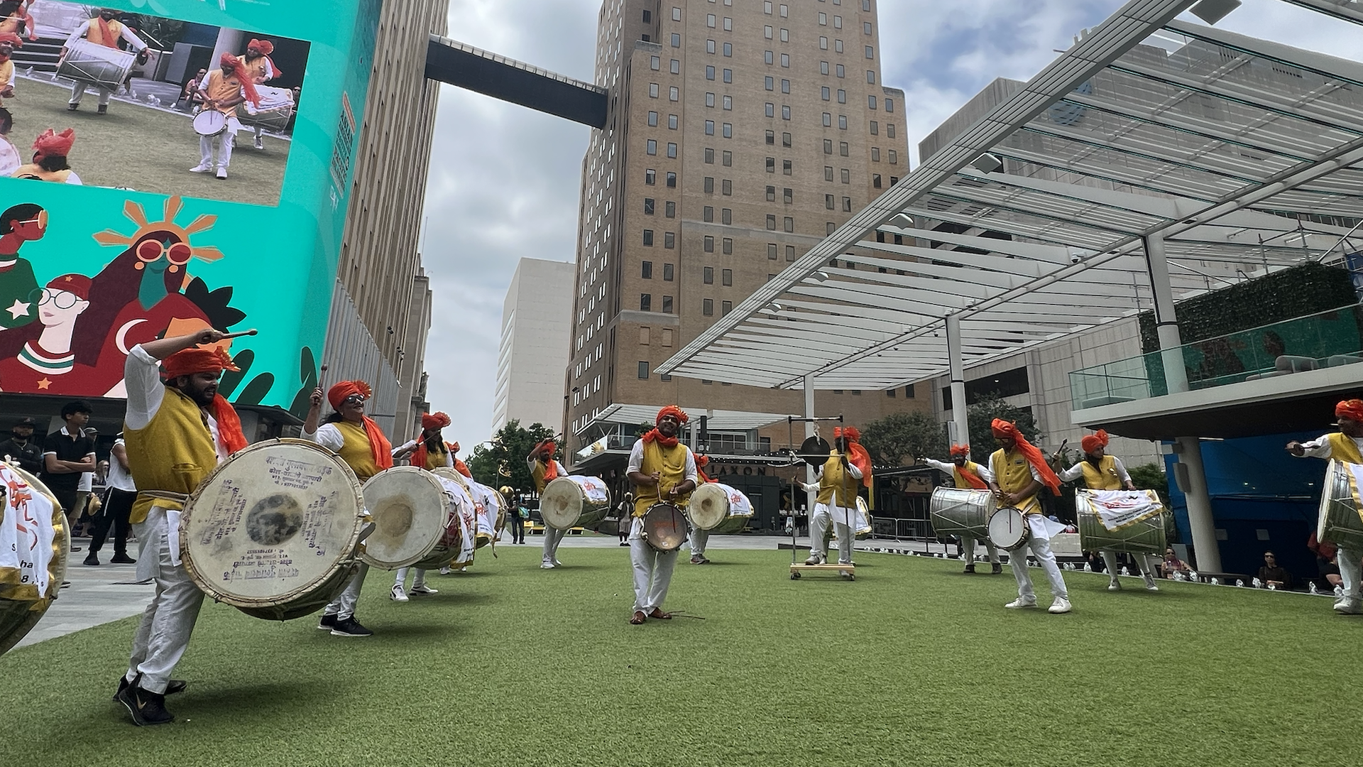 Group of drummers performing on green turf to celebrate Asian American Native Hawaiian & Pacific Islander Heritage Month.