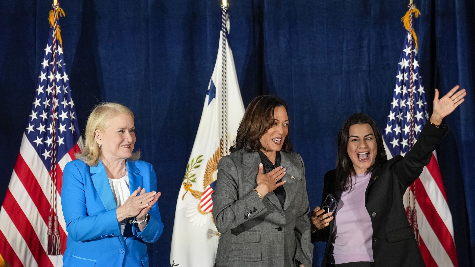 Rep. Sylvia Garcia, left, Vice President Kamala Harris, and Rep. Nanette Barragan wave to the crowd at the end of a community discussion organized by the Congressional Hispanic Caucus on Monday, Nov. 27, 2023 in Houston.