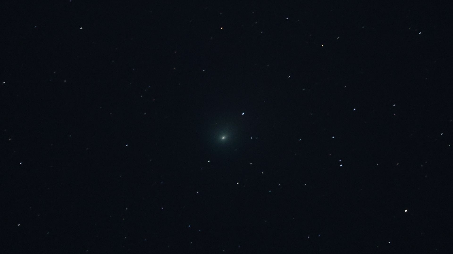 A green comet visible in the sky 