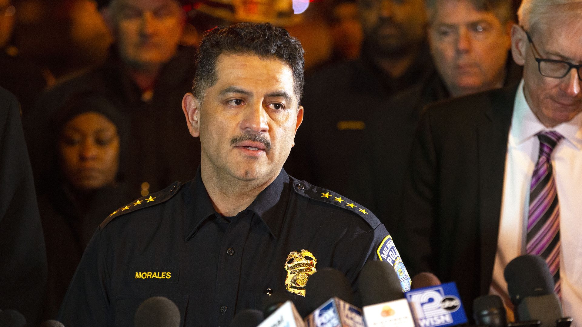 Milwaukee Police Chief Alfonso Morales speaks at a press conference surrounded be people