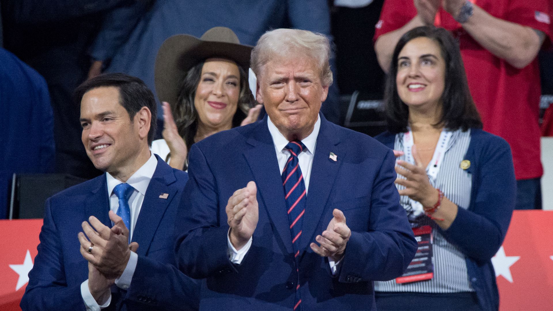Donald Trump (center) claps during RNC 24 convention. He has a white bandage on his ear.