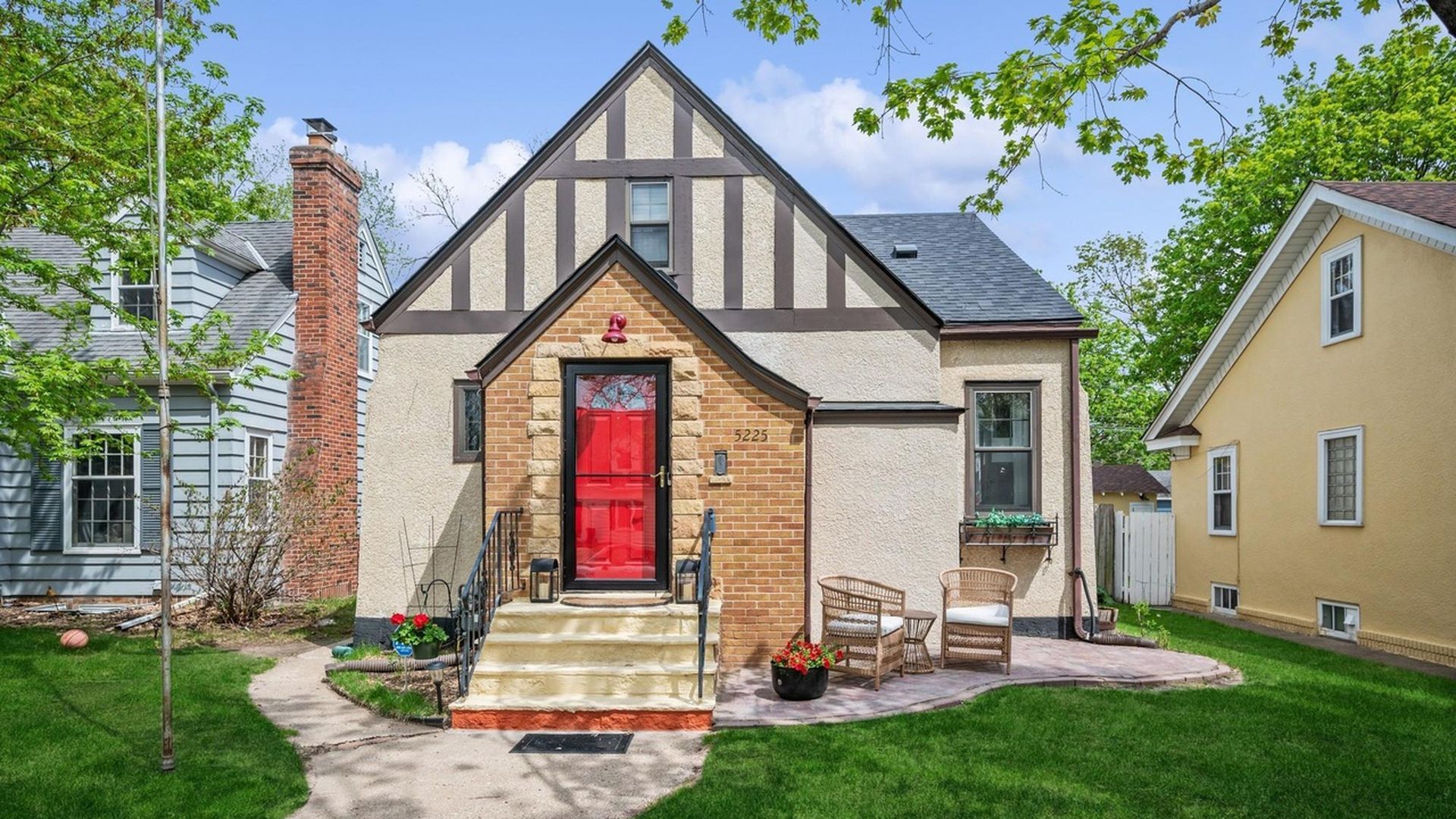 exterior view of Tudor home with bright red door