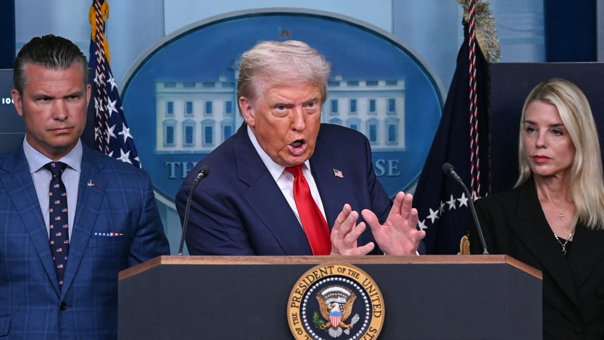 US President Donald Trump, alongside Secretary of Defense Pete Hegseth (L) and Attorney General Pam Bondi (R), speaks during a news conference at the White House in Washington, DC. Photo by Andrew Caballero-Reynolds via AFP via Getty Images