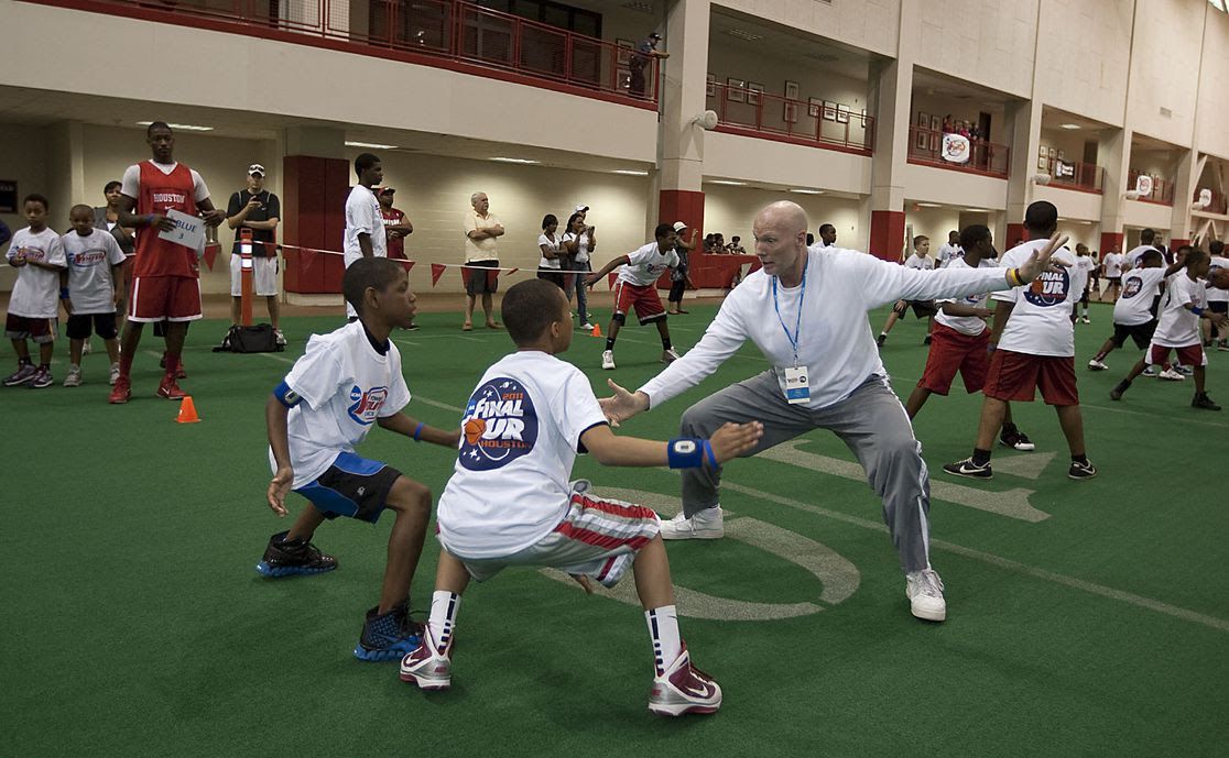 Children playing games in a gym. History of Youth Sports in the US