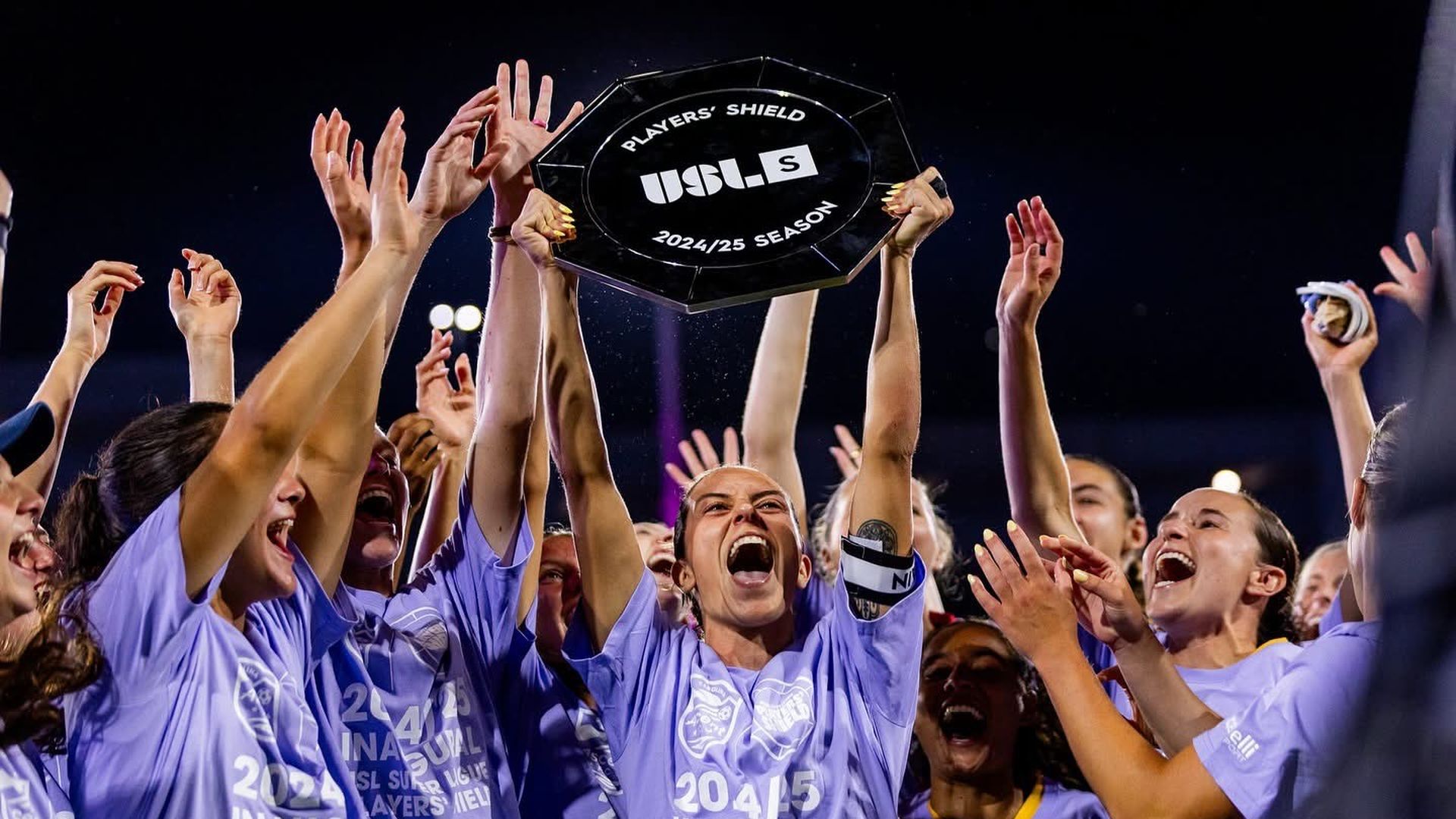 Carolina Ascent players in purple shirts hoist the inaugural Players' Shield. 