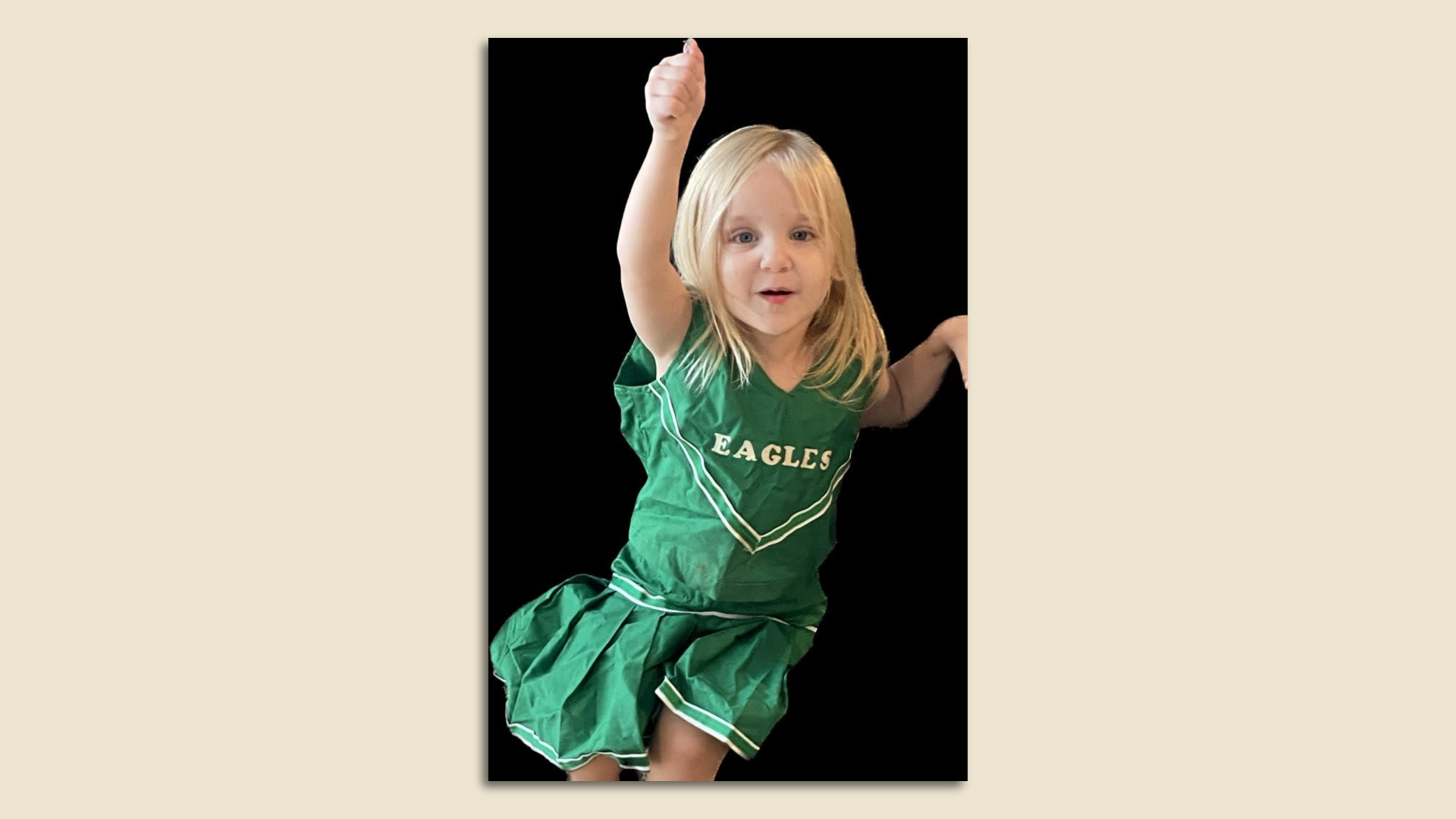 A young girl wearing an Eagles dress