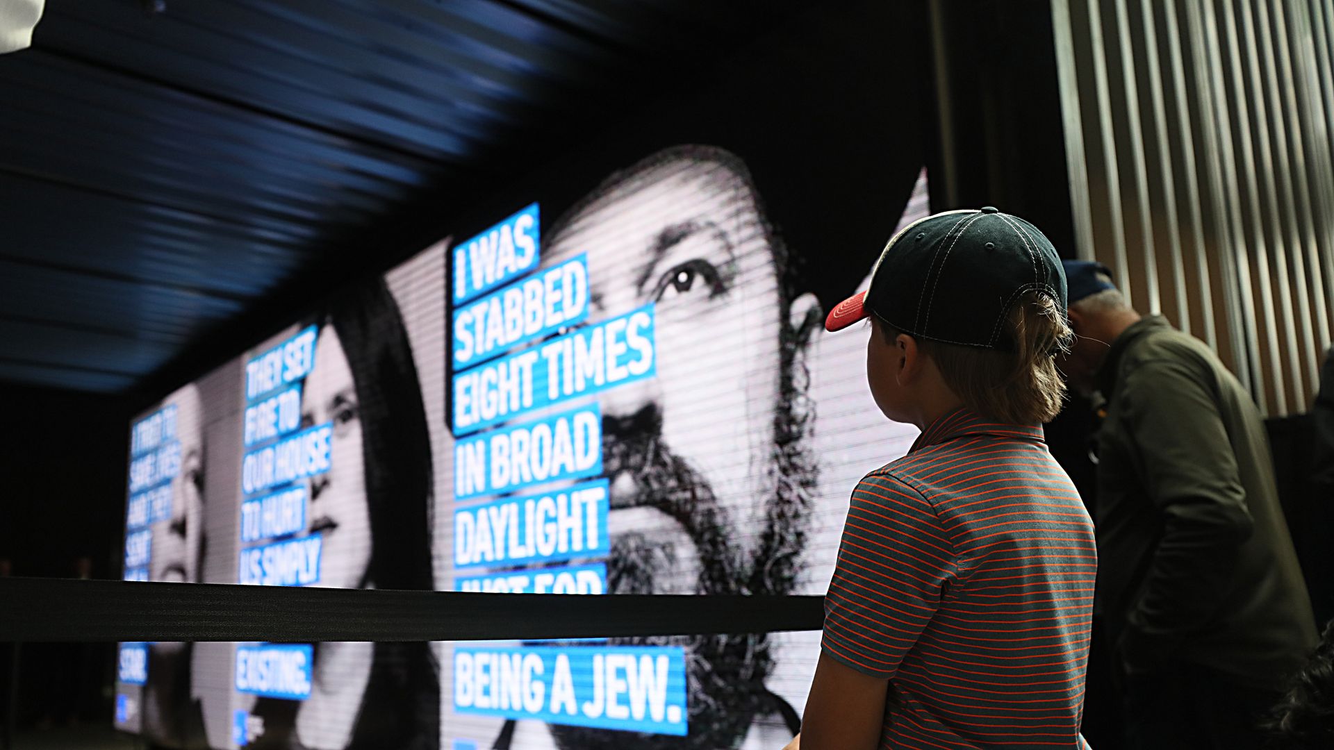 A child watches the press conference at Boston's North Station for the Face Jewish Hate campaign.