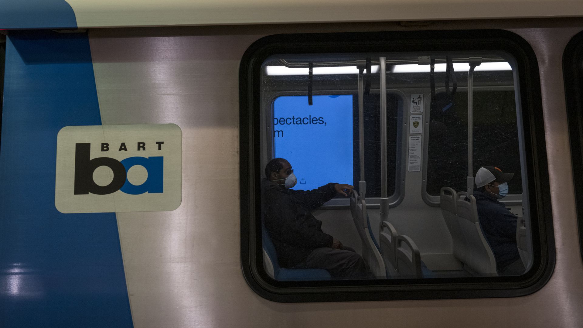 Photo of a BART train car with people sitting inside