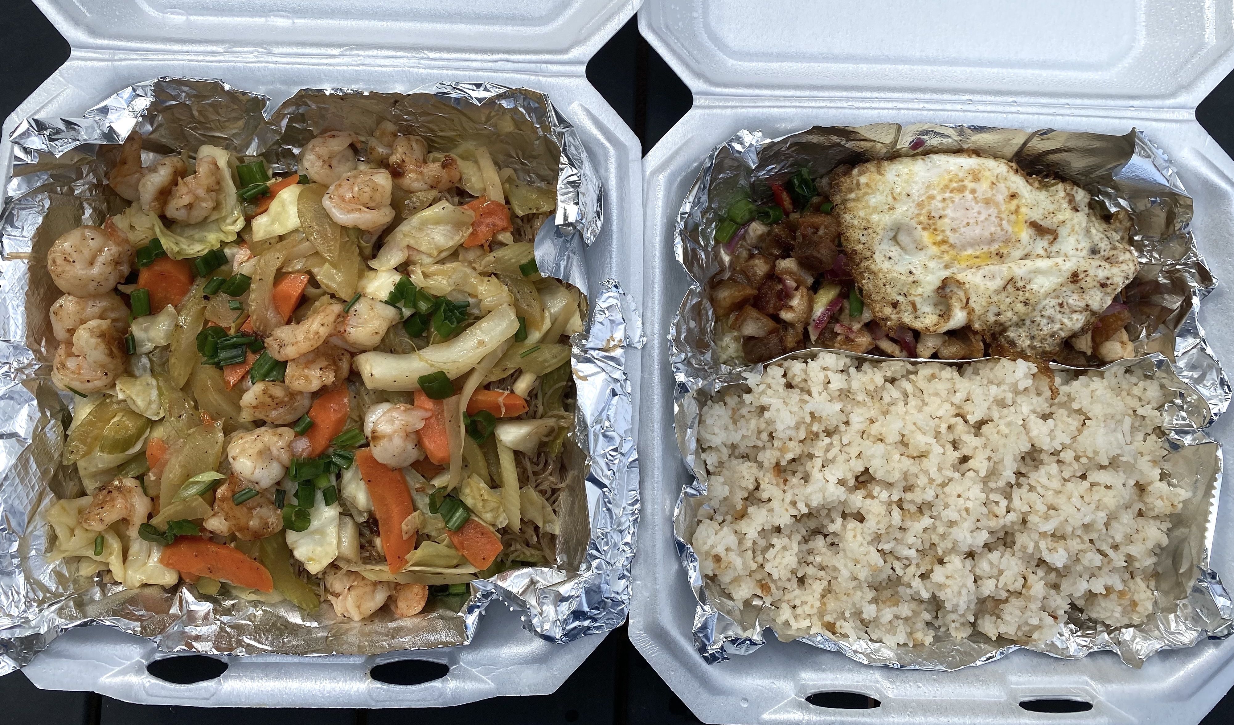 Filipino dishes, Pork Sisig and shrimp Pancit in to-go boxes. 