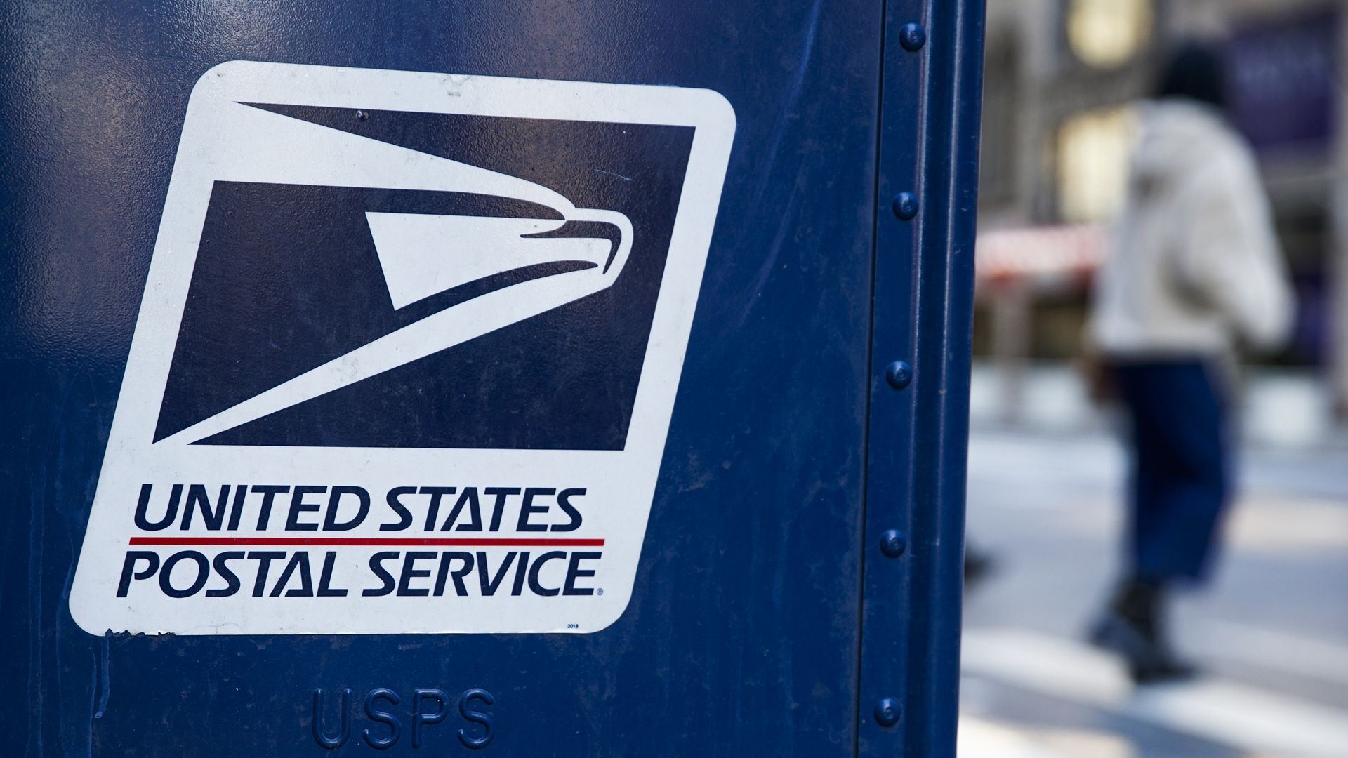 A mailbox, with focus on the United States Postal Service logo
