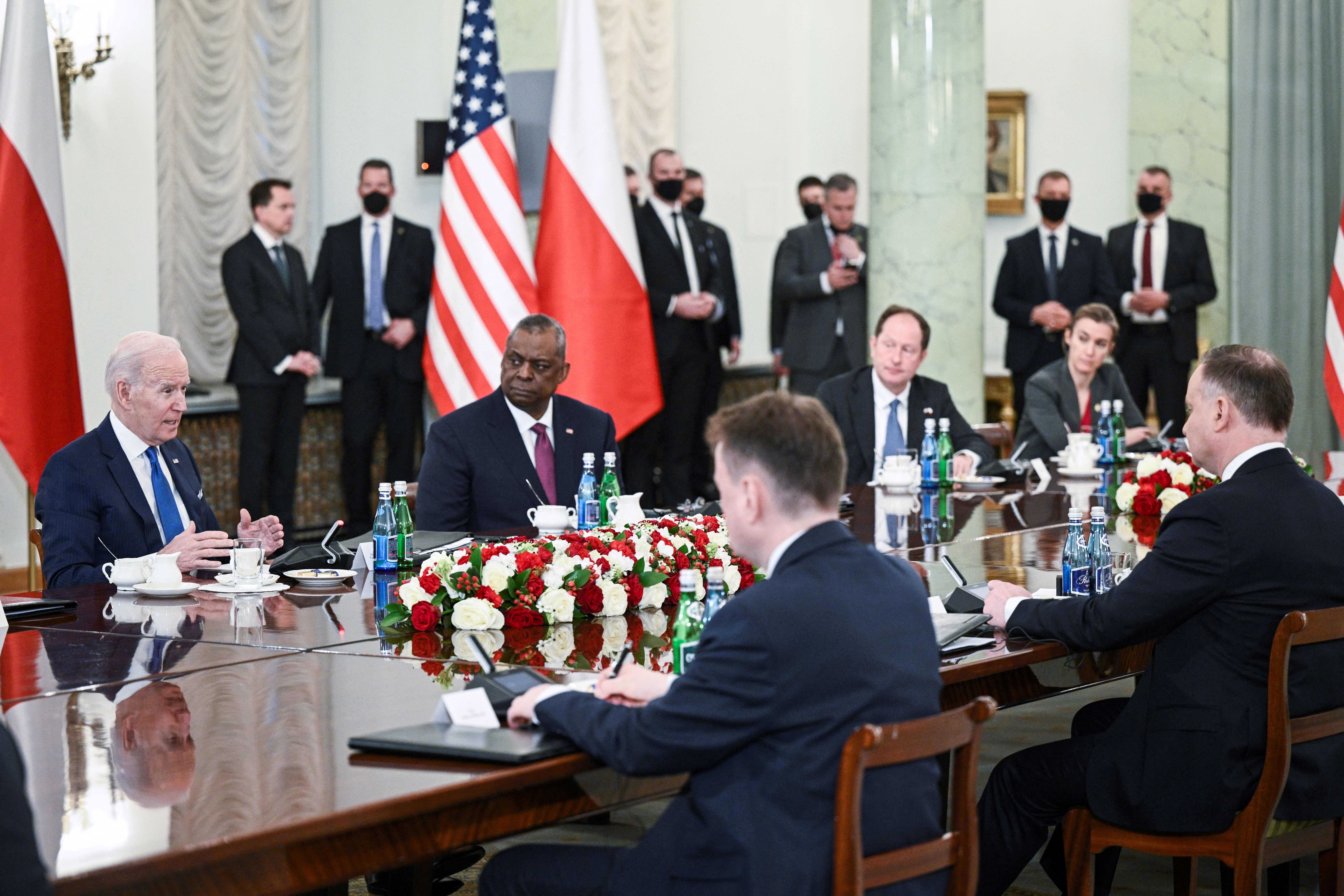 President Joe Biden (L) together with US Defence Secretary Lloyd Austin (2ndL) attends a meeting with Polish President Andrzej Duda (R) at the presidential palace in Warsaw on March 26, 2022. 